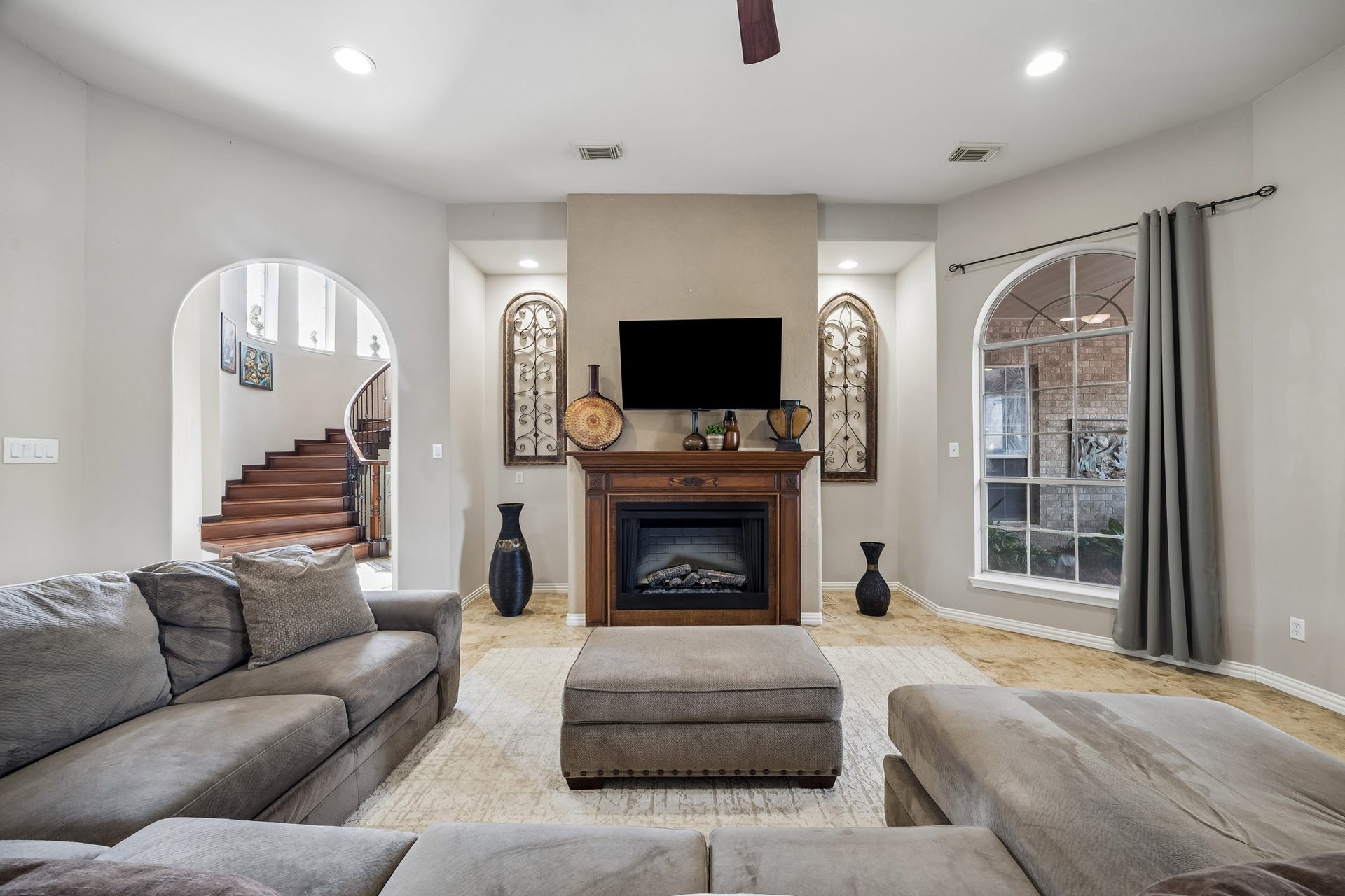 1319 Brazoswood Place, Richmond, TX 77406 This spacious living area blends warmth and sophistication with a classic fireplace, and beautifully connected entertaining spaces.