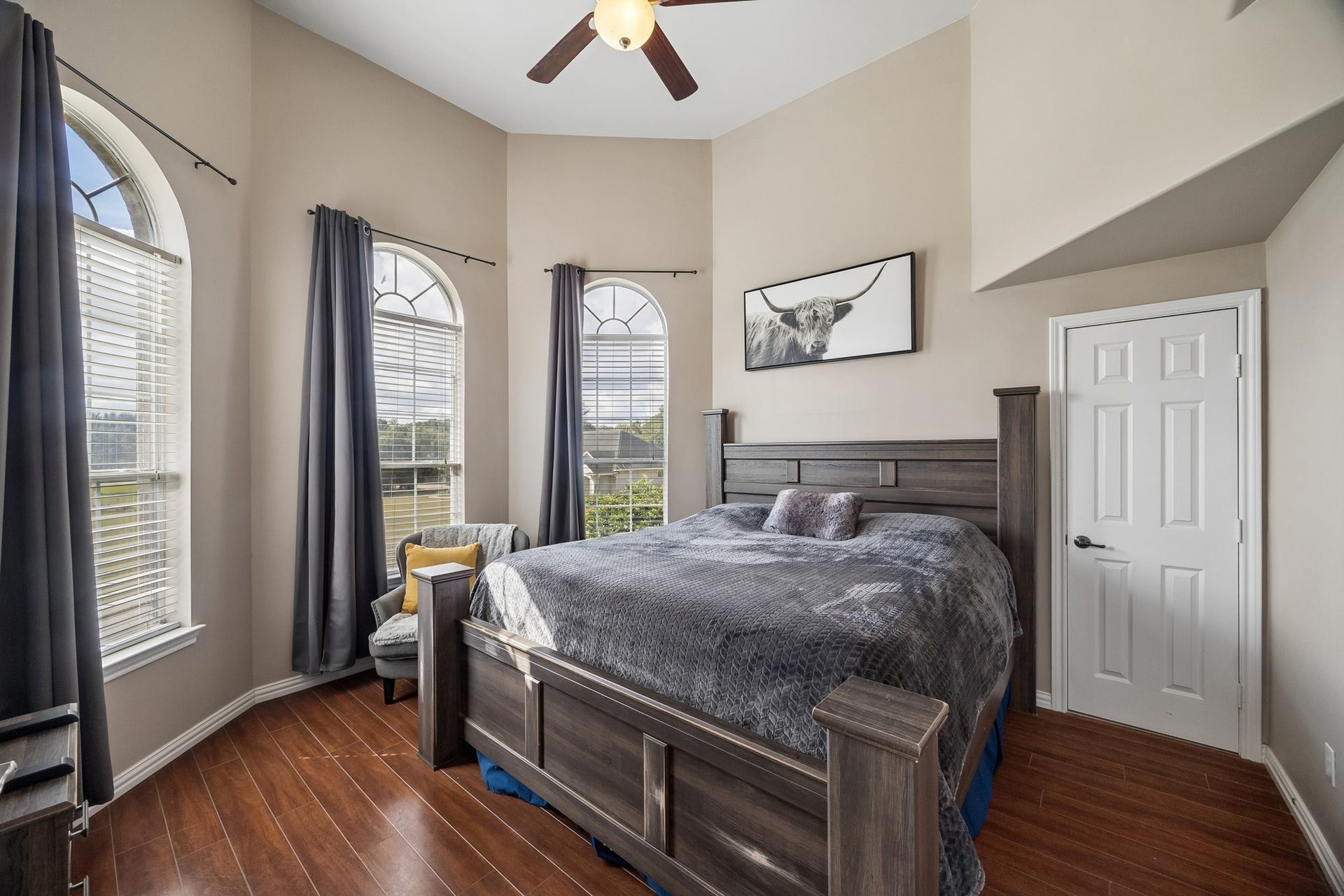 1319 Brazoswood Place, Richmond, TX 77406 Sizable secondary bedroom with ensuite bathroom. Notice the serene views with continuous engineered hardwoods and fan.