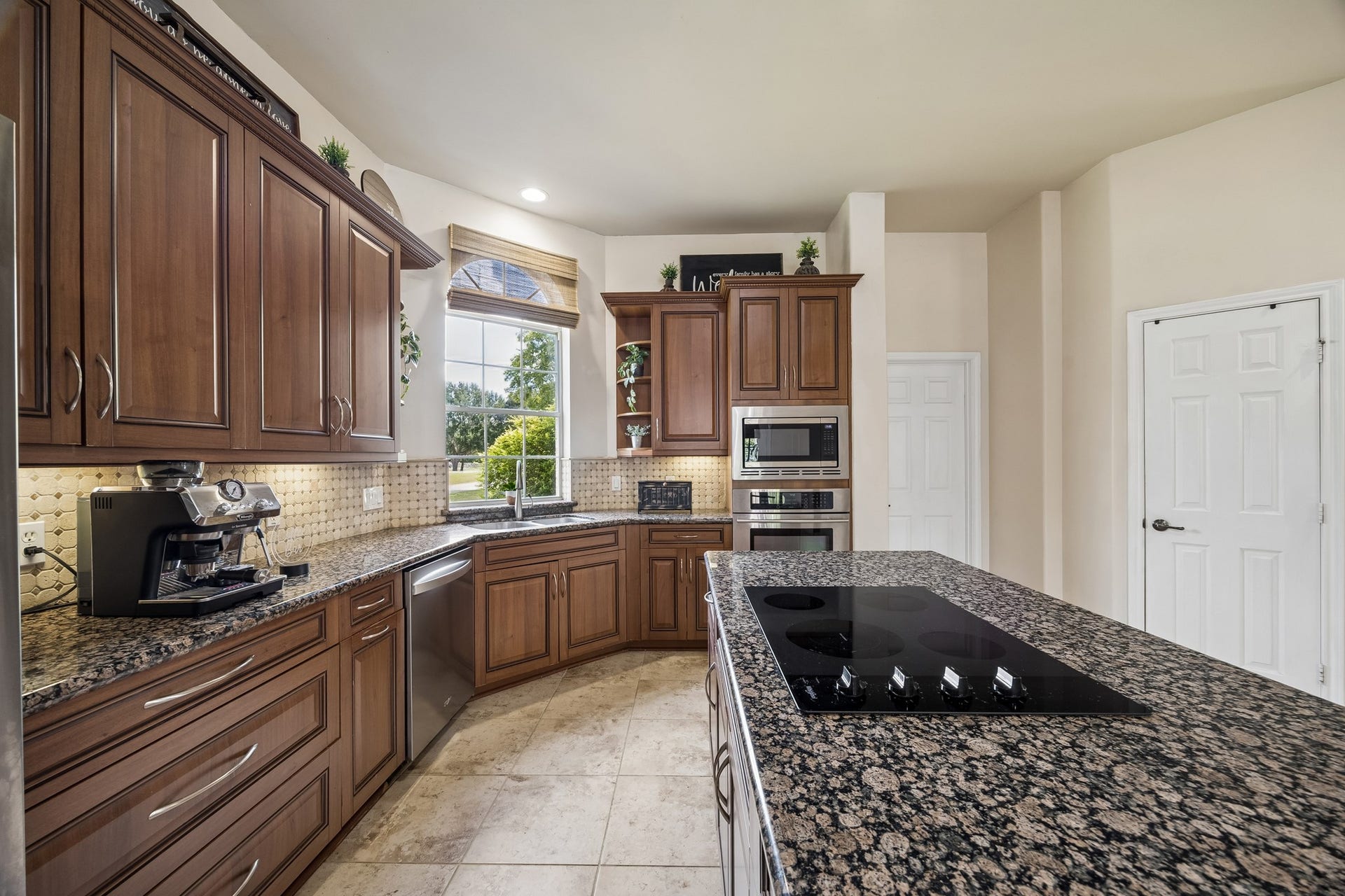 1319 Brazoswood Place, Richmond, TX 77406 Kitchen views with the laundry room door and pantry just ahead.