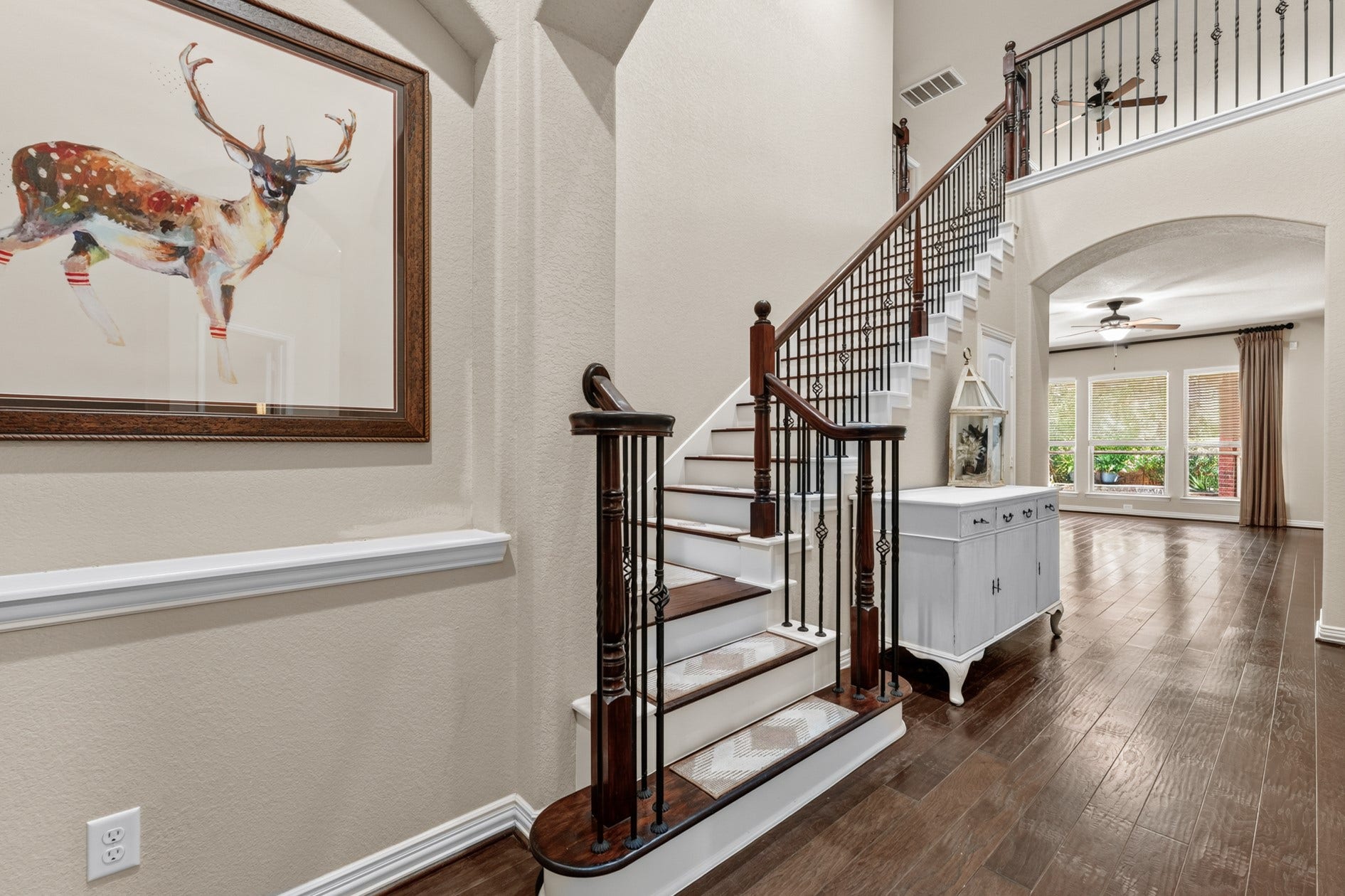 3 Blue Wildflower Pl, The Woodlands, TX 77354 A gorgeous staircase with wood and iron balusters leads to the game room and media room.
