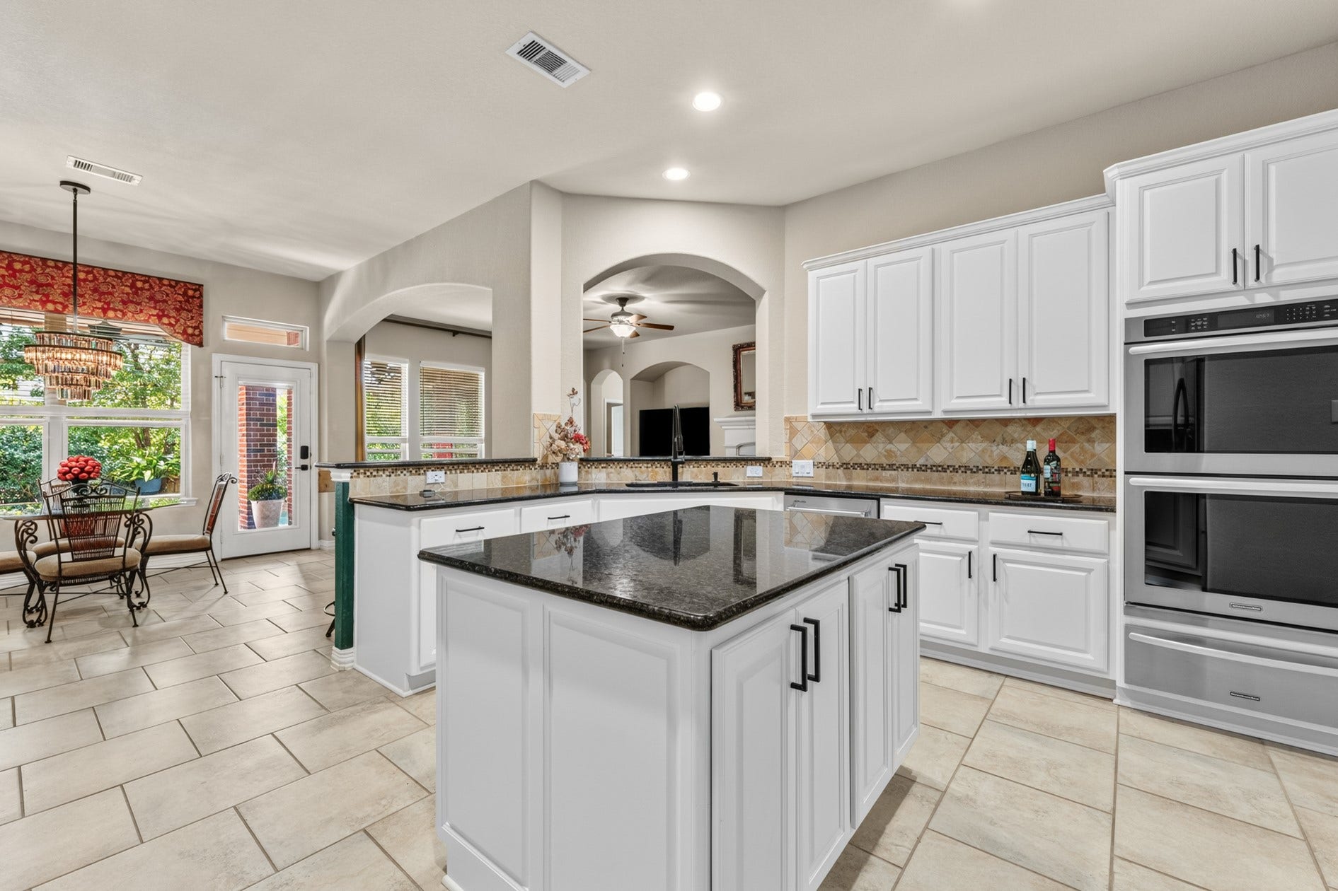 3 Blue Wildflower Pl, The Woodlands, TX 77354 This spacious well-appointed kitchen will be enjoyed by all. Lots of storage, tiled backsplash, timeless white cabinetry, and stainless steel appliances provide beauty and practicality for everyday living. Double-ovens and a warming drawer make cooking for large gatherings easy!