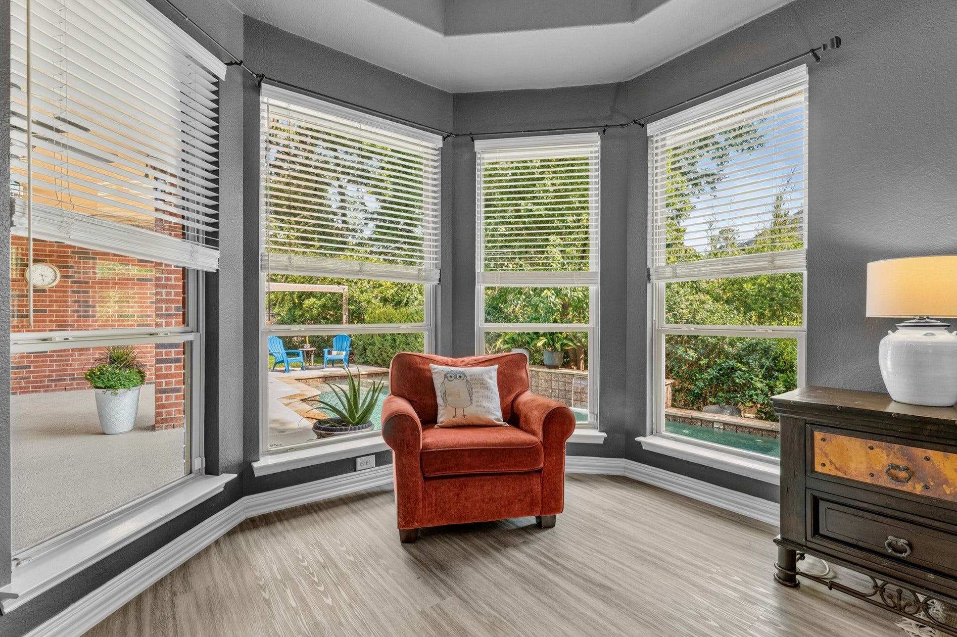 3 Blue Wildflower Pl, The Woodlands, TX 77354 The sitting area is the perfect spot to take in the beauty of the sparkling pool and private backyard.