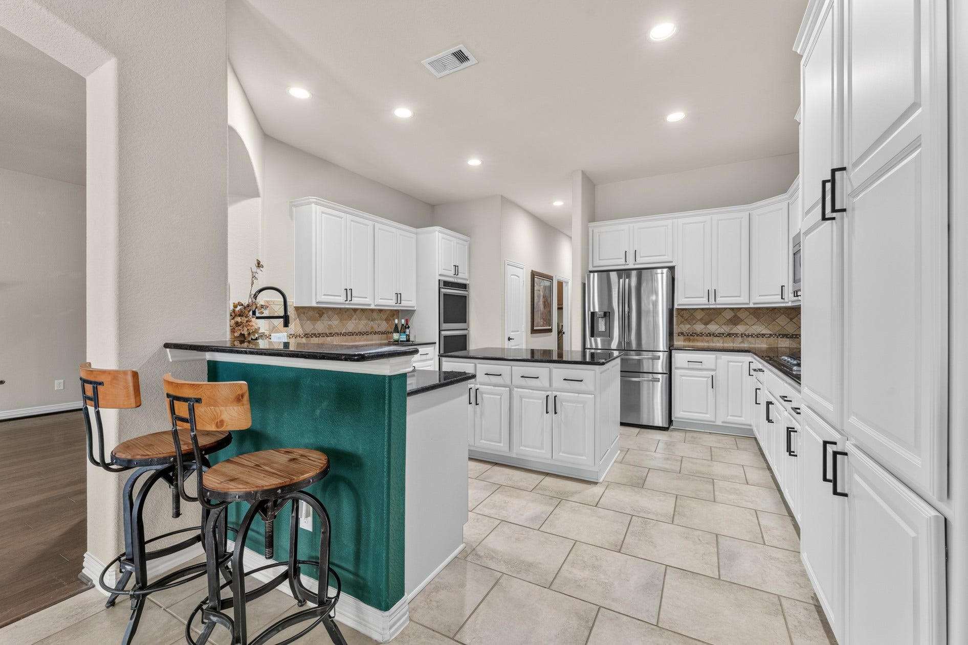 3 Blue Wildflower Pl, The Woodlands, TX 77354 This roomy kitchen offers an abundance of storage with wrap around cabinets on three sides, cabinets in the island, a wall pantry, AND a walk-in pantry.