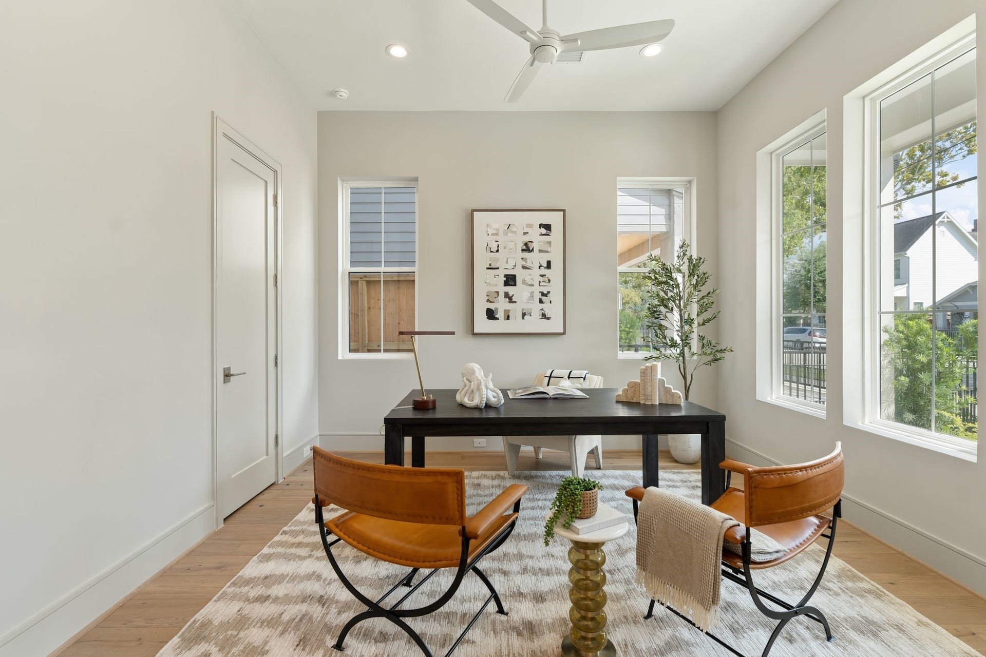 711 E 12th Street, Houston, TX 77008 Expansive windows fill this versatile study with natural light, while warm hardwood floors create an inviting setting. A closet and nearby full bathroom allow the space to double as a comfortable first-floor bedroom.