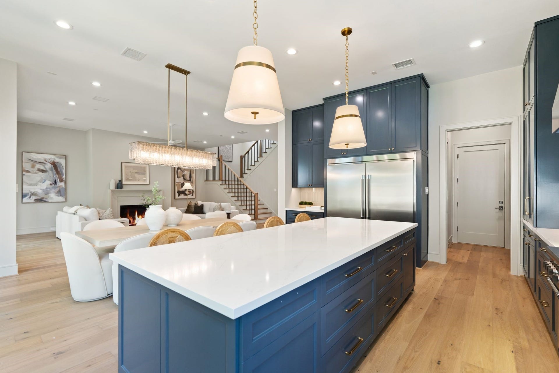 711 E 12th Street, Houston, TX 77008 Close view of the substantial kitchen island, showcasing polished quartz, elegant cabinetry and a sophisticated material palette.