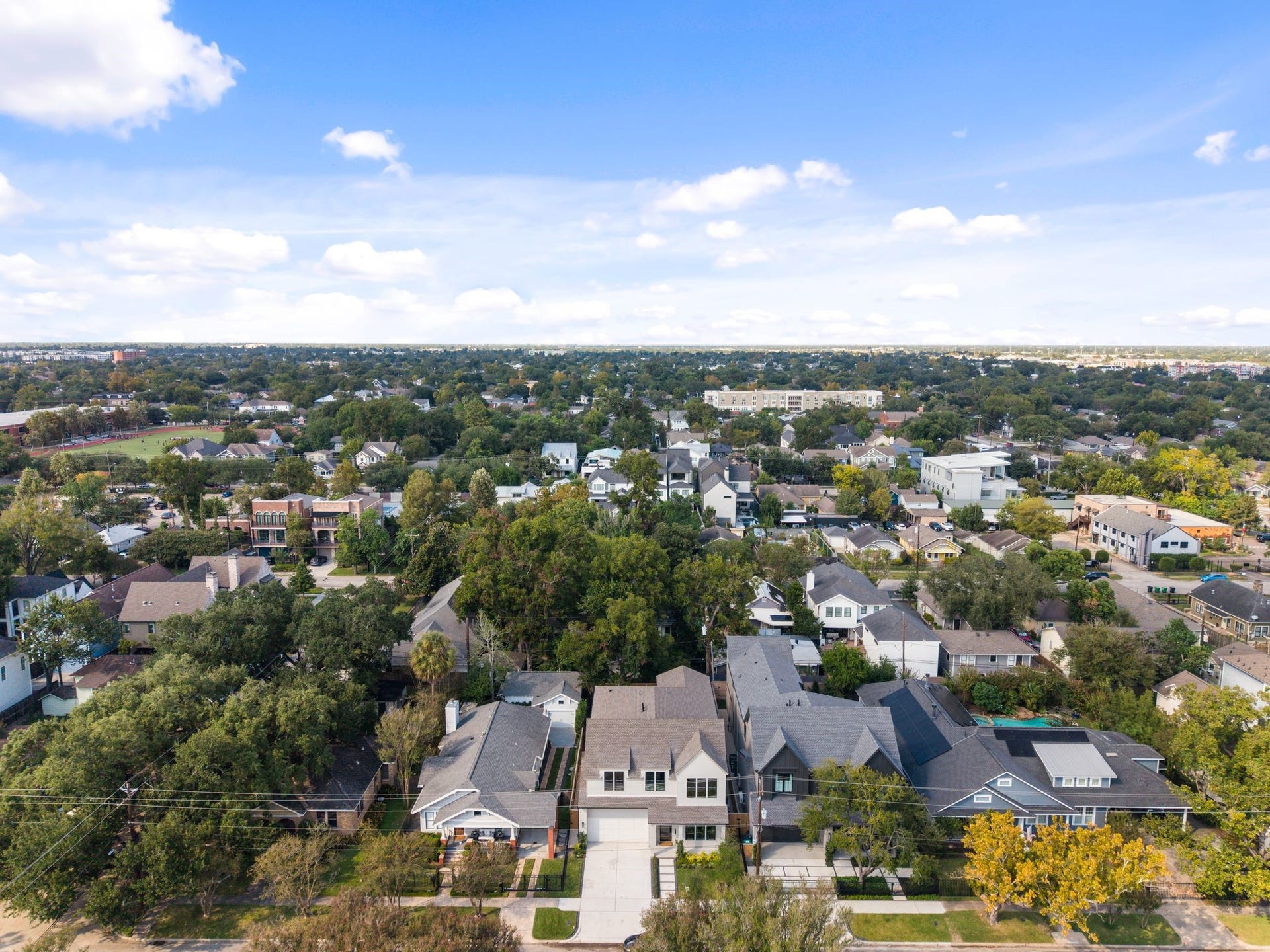 711 E 12th Street, Houston, TX 77008 A neighborhood perspective captures the appeal of Heights living: tree-lined streets, distinctive homes, and Houstons skyline on the horizon. At 711 E 12th, neighborhood charm and city connection come together.