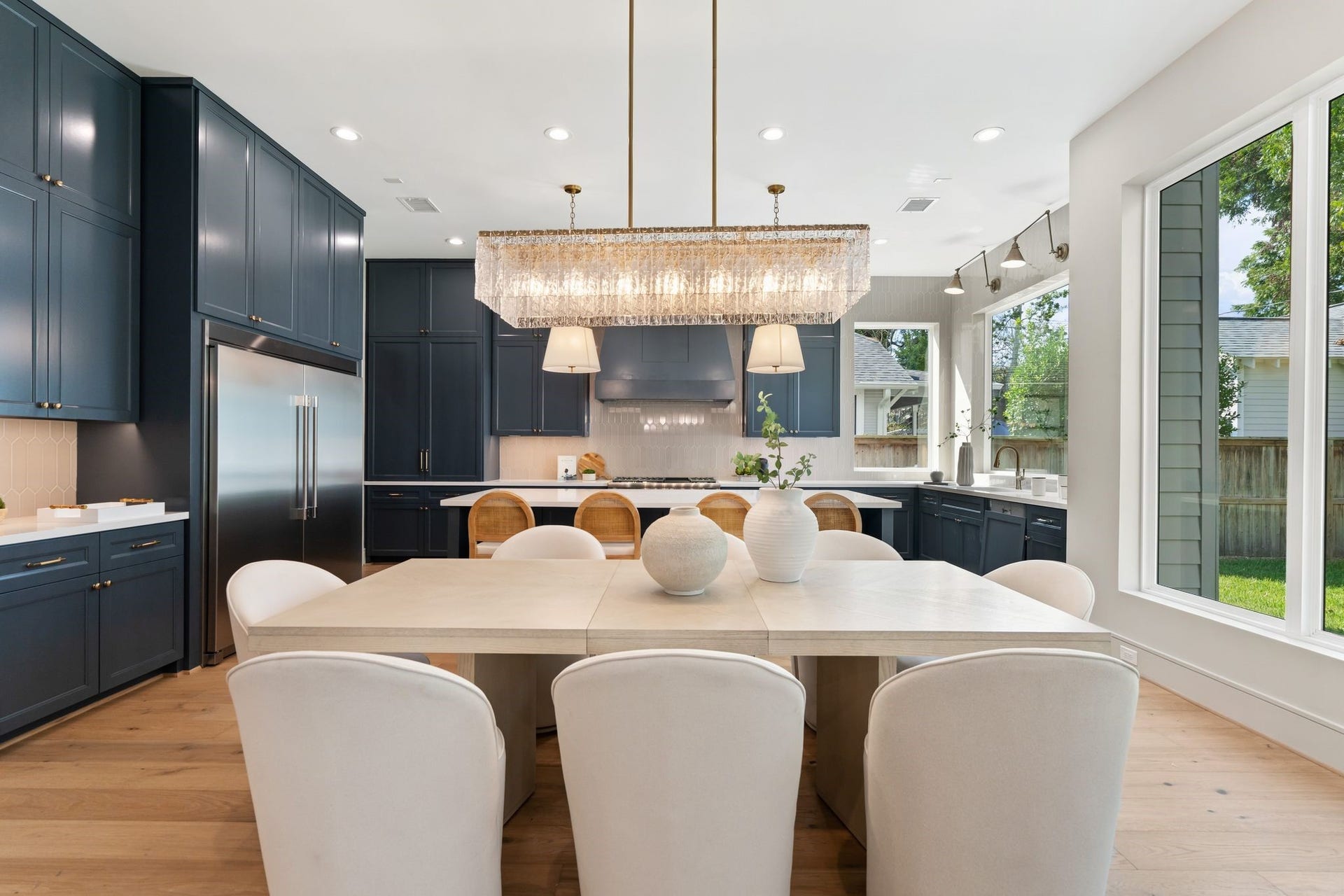711 E 12th Street, Houston, TX 77008 The dining room's open connection to the kitchens generous island and the adjoining great room keeps conversation flowing, with warm hardwood floors tying the spaces together.