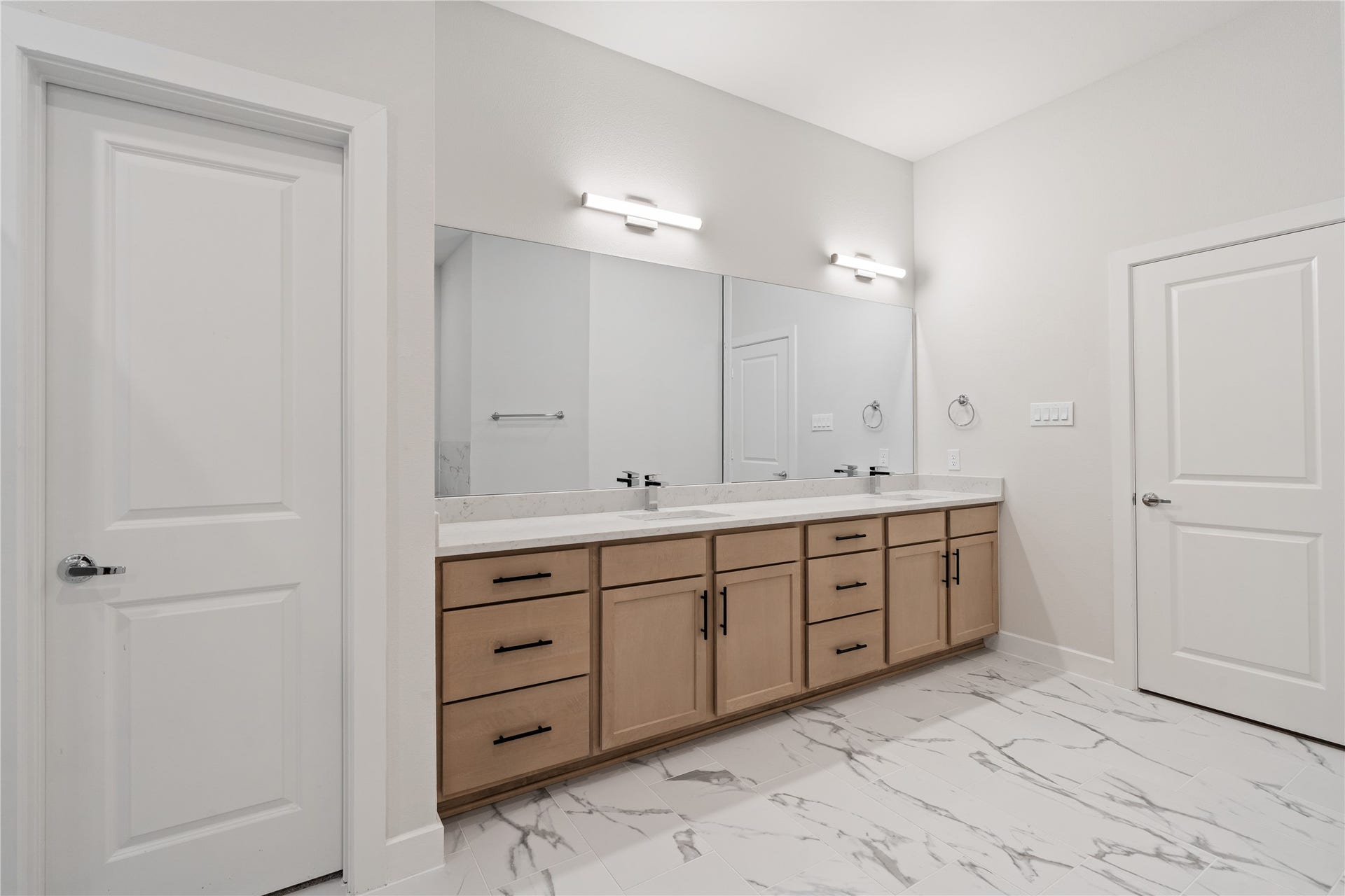 6509 Rena Street, Houston, TX 77092 Natural wood cabinetry and quartz surfaces keep the design warm and modern while maintaining a clean, uncluttered feel.