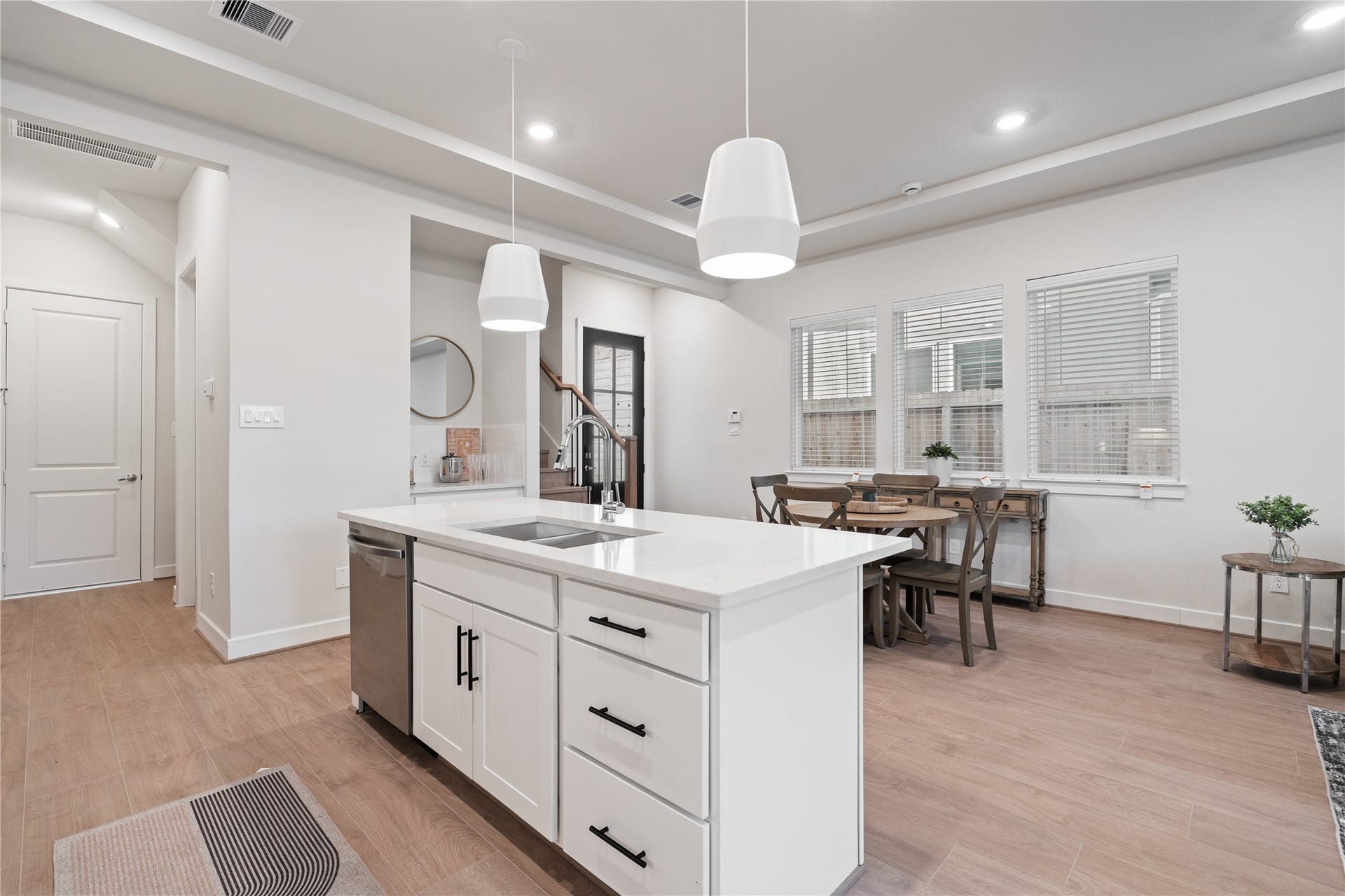 6509 Rena Street, Houston, TX 77092 Swiss engineered hardwood runs throughout the first floor, adding warmth that balances the clean white finishes.