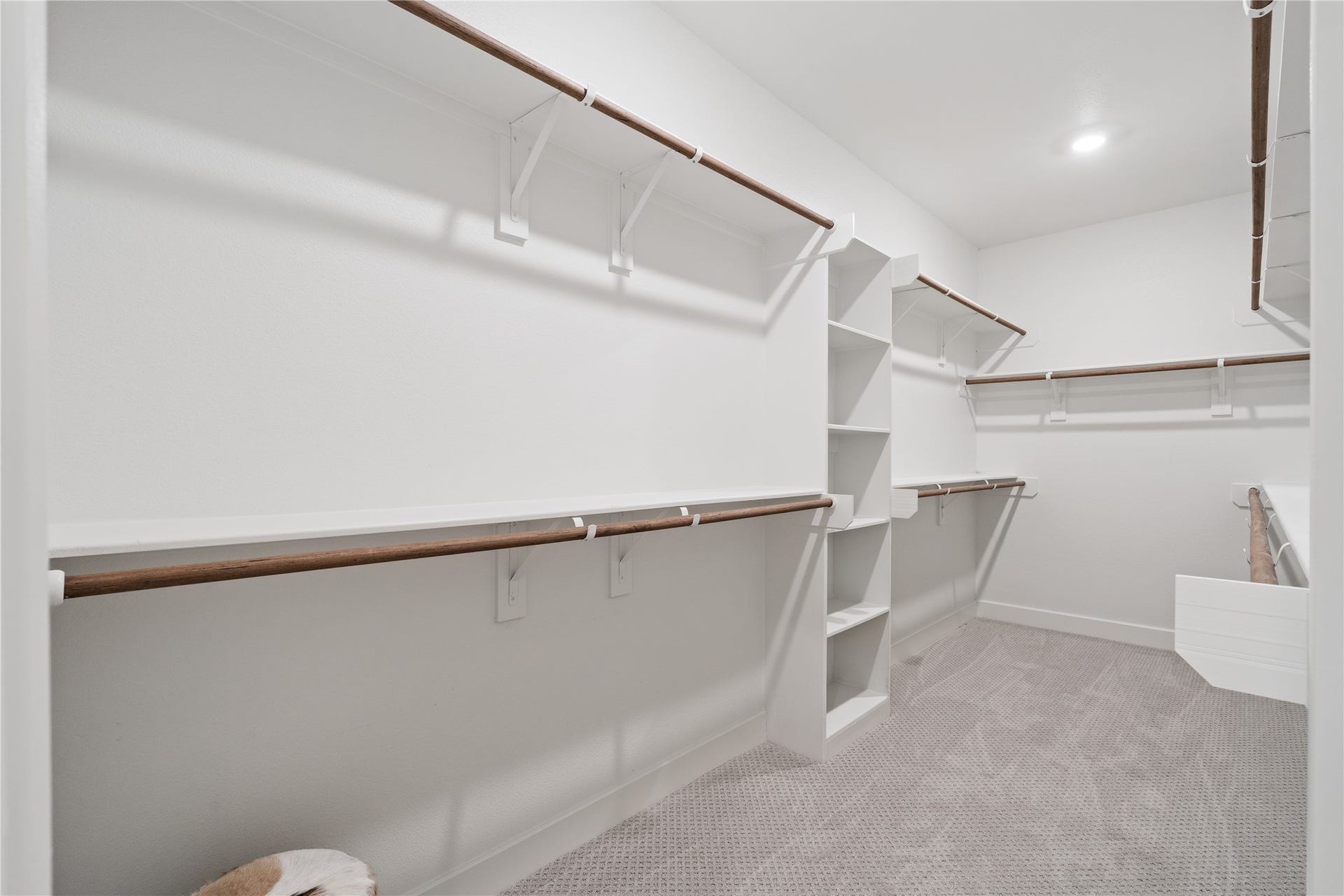 6509 Rena Street, Houston, TX 77092 Expansive walk in closet with multiple hanging sections and built in shelving for structured organization.
