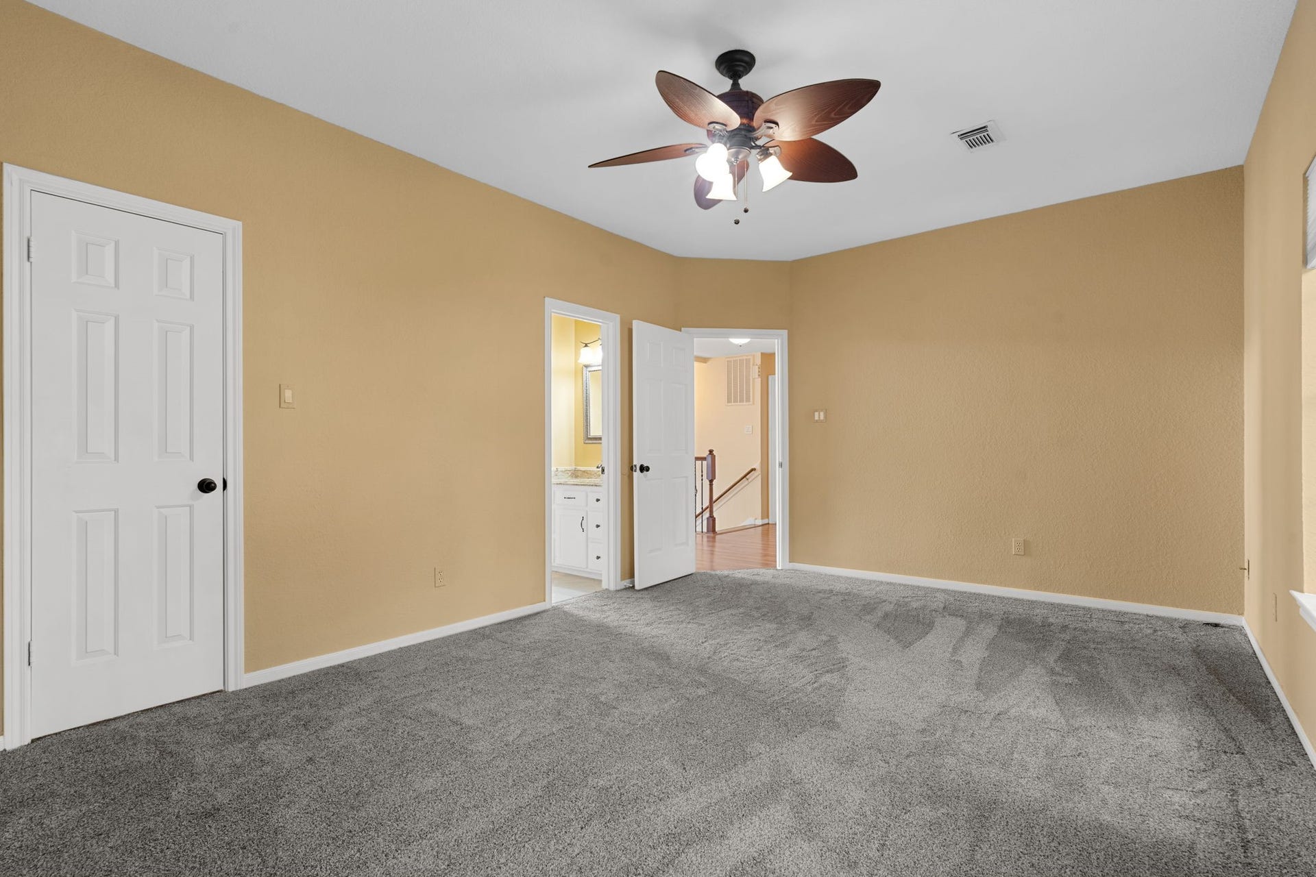 23 Saint Simons Court, Sugar Land, TX 77479 Previously serving as a home office, this large bedroom includes a walk-in closet and en suite bath, perfect for guests or family.