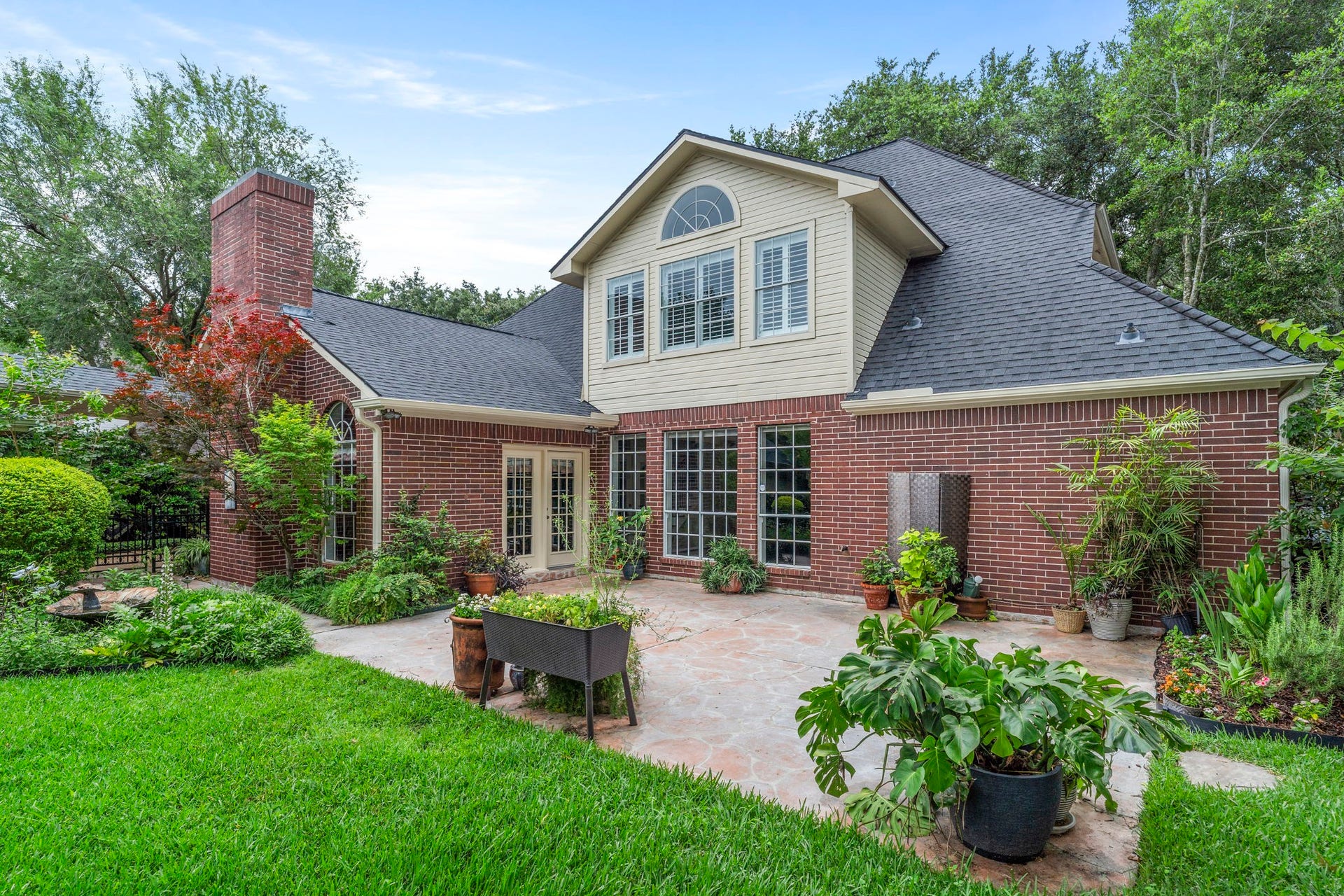 23 Saint Simons Court, Sugar Land, TX 77479 Enjoy the outdoors on the delightful back patio, set amidst meticulously designed gardens and mature greenery.