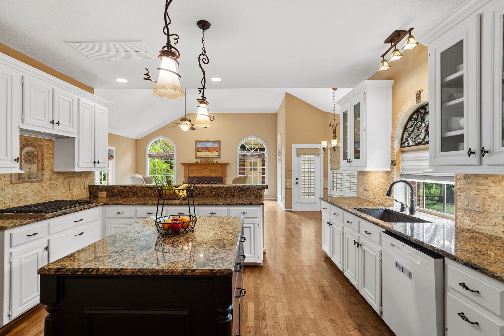23 Saint Simons Court, Sugar Land, TX 77479 The well-appointed kitchen features a generous island, separate breakfast bar, granite countertops, walk-in pantry, pot-and-pan drawers, under-cabinet lighting, and double convection ovens, along with a new gas cooktop installed in 2026 and dishwasher installed in 2025.