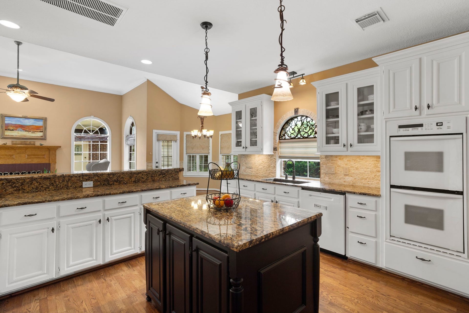 23 Saint Simons Court, Sugar Land, TX 77479 The kitchen features double convection wall ovens, a gas cooktop, and microwave.