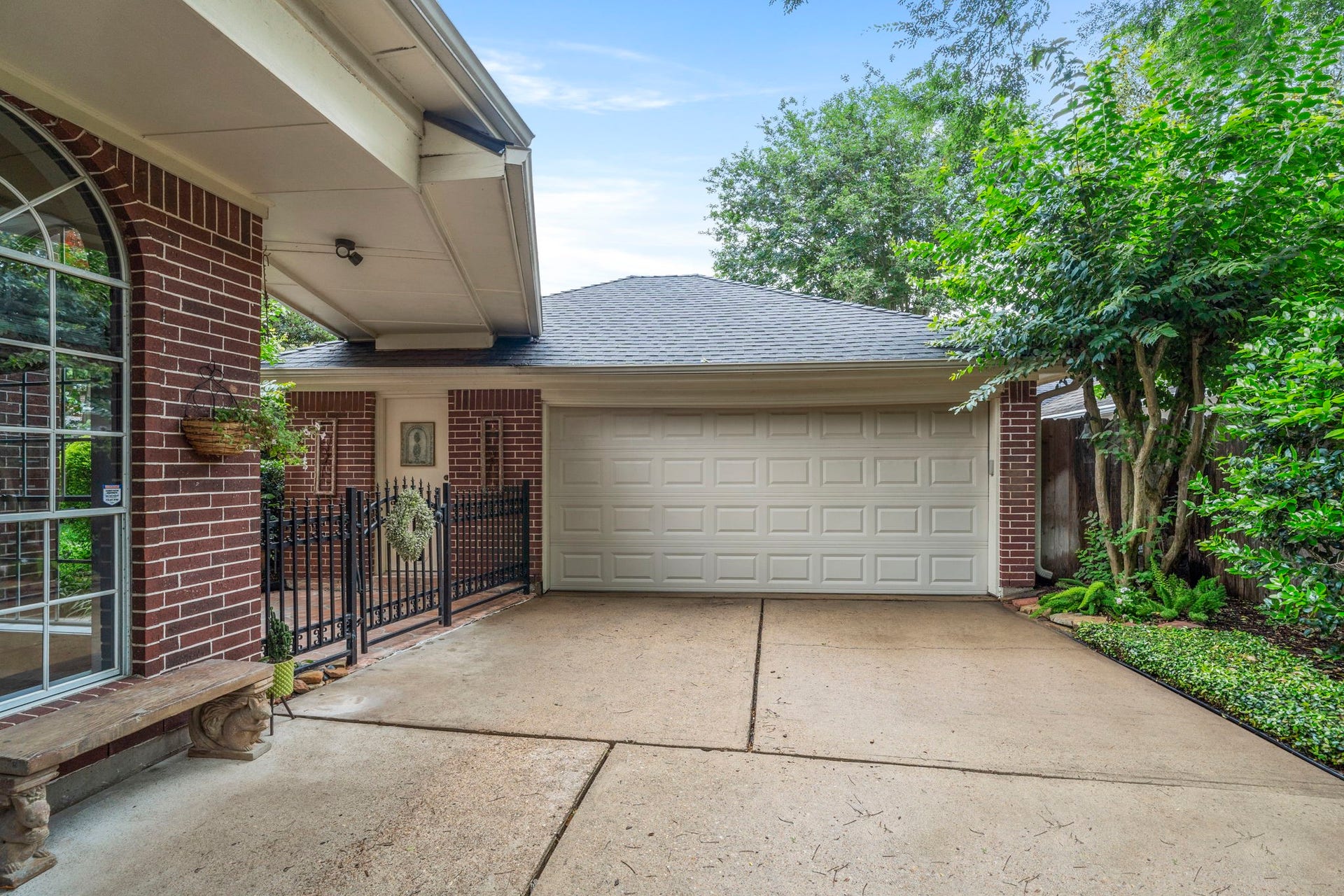 23 Saint Simons Court, Sugar Land, TX 77479 An open breezeway provides a protected walkway between the house and oversized two-car garage, offering convenient all-weather access.