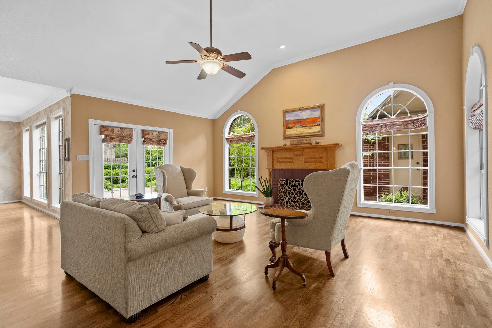 23 Saint Simons Court, Sugar Land, TX 77479 A handsome gas-log fireplace anchors the inviting family room, complemented by soaring ceilings and gracefully arched windows that fill the space with natural light.