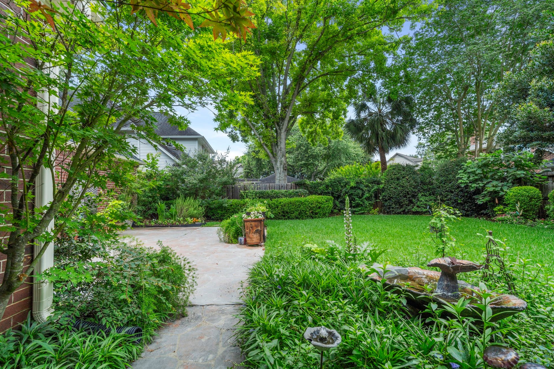 23 Saint Simons Court, Sugar Land, TX 77479 A thoughtfully designed, professionally landscaped yard highlights a diverse selection of native plantings.