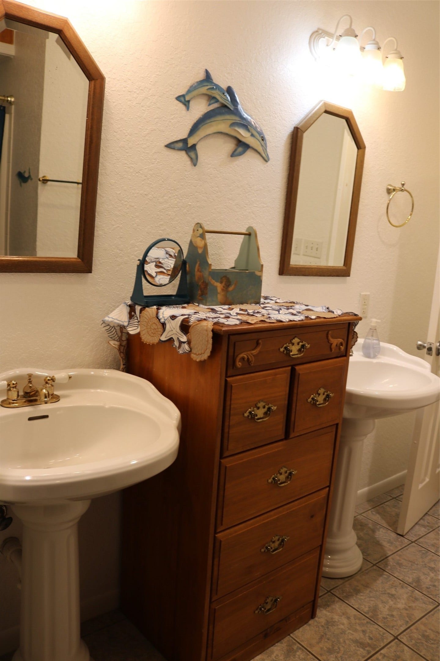 13002 Buccaneer Parkway, Freeport, TX 77541 Maritime themed master bathroom featuring double sinks, a private toilet area, and a versatile bath/shower combination.