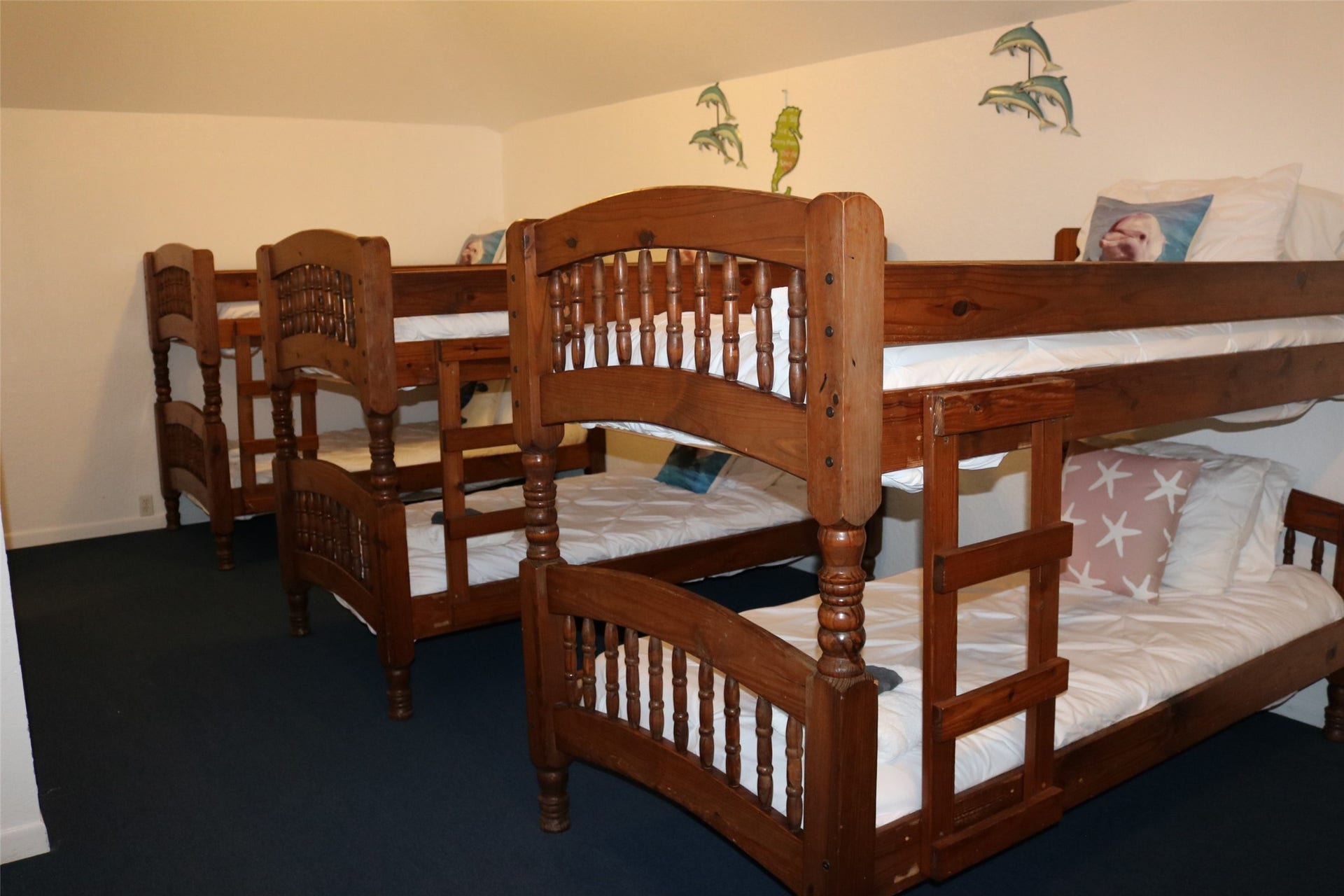 13002 Buccaneer Parkway, Freeport, TX 77541 The third-level guest room features three sets of durable wooden bunk beds, perfect for accommodating multiple guests comfortably.
