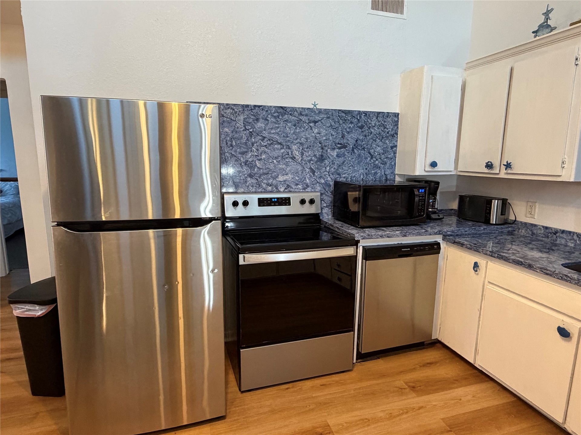 13002 Buccaneer Parkway, Freeport, TX 77541 Modern kitchen with sleek freestanding refrigerator, stove, and dishwasher.