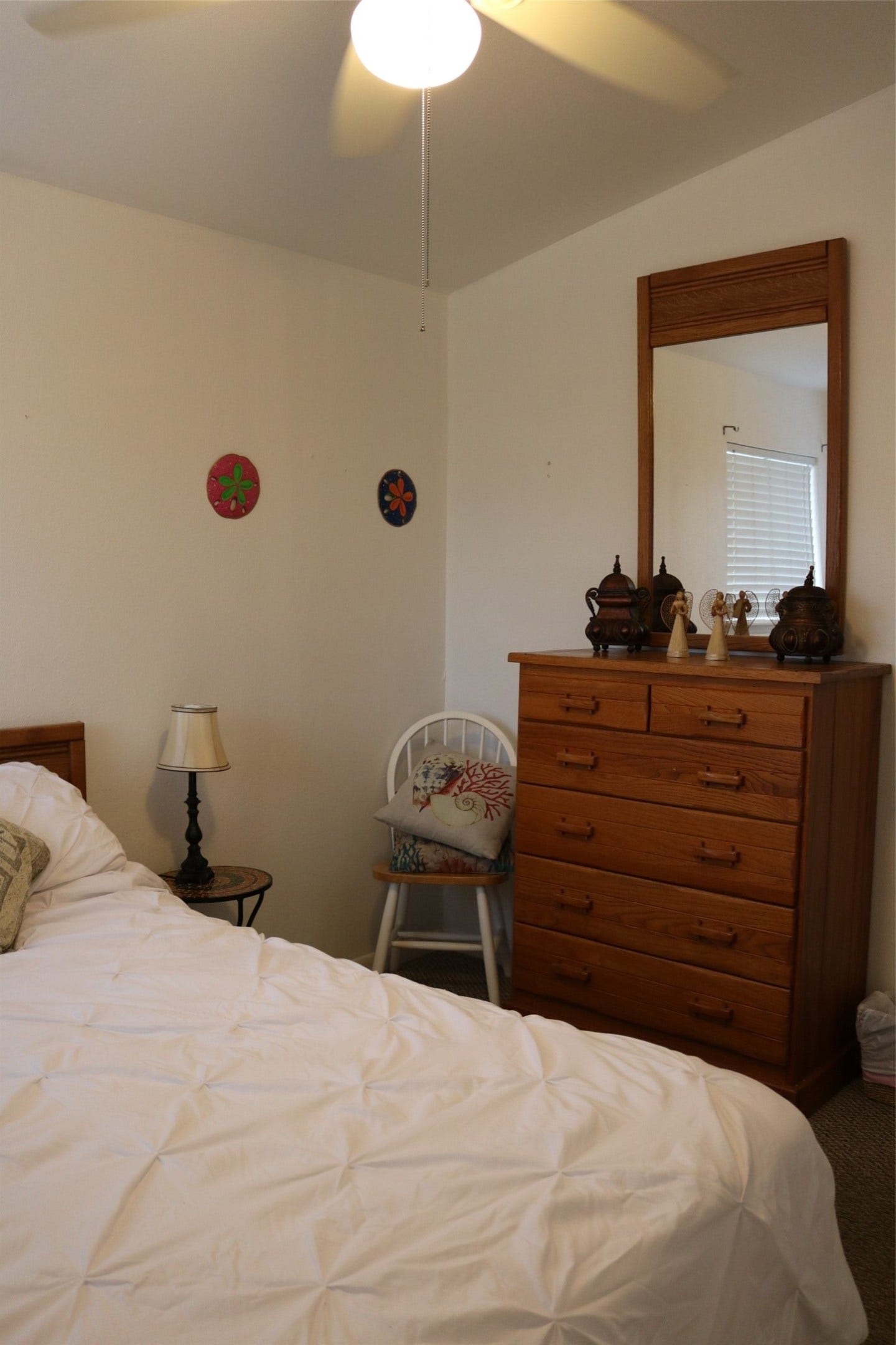 13002 Buccaneer Parkway, Freeport, TX 77541 Cozy guest room featuring a comfortable queen-size bed and ample storage with a stylish dresser.