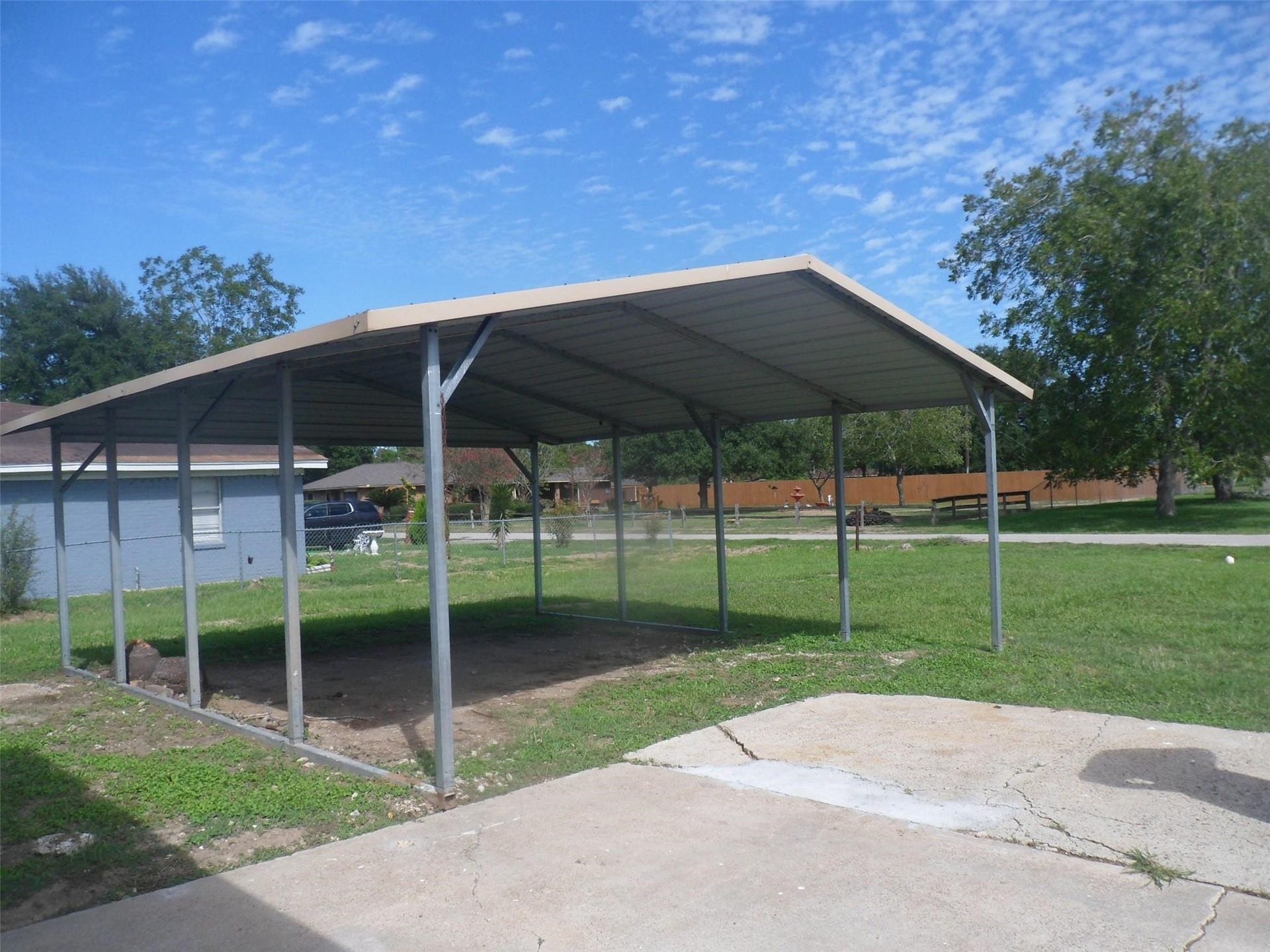 6510 Highway 6, Hitchcock, TX 77563 Spacious 2-car carport offers convenient and sheltered parking, enhancing your home's functionality and curb appeal.