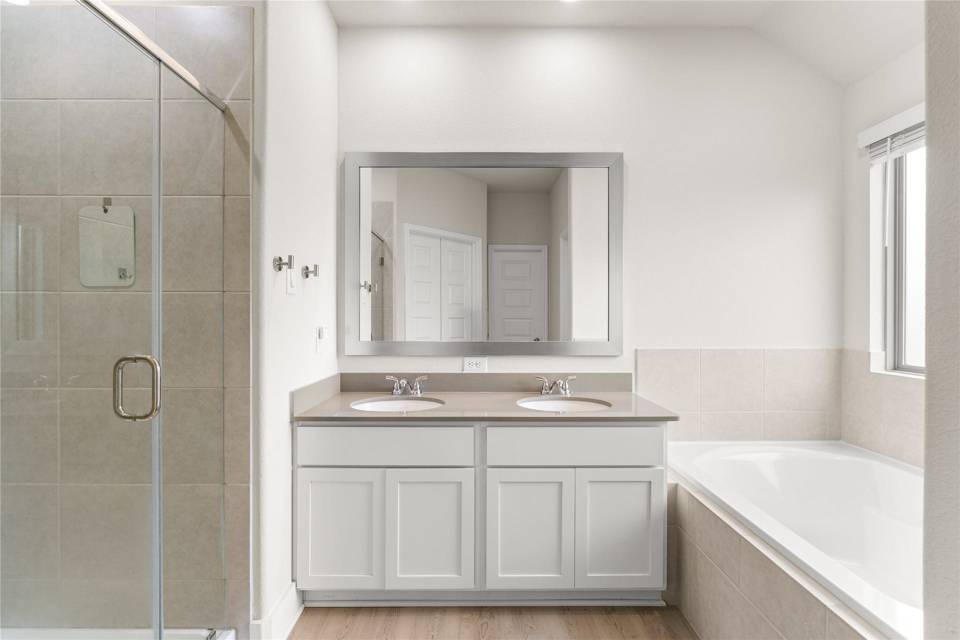 4001 Baja Lane, Houston, TX 77045 Designed to support the morning routine with ease, the primary ensuite features dual vanities, a dedicated glass-enclosed shower, and a soaking tub, allowing multiple functions to happen comfortably at once.