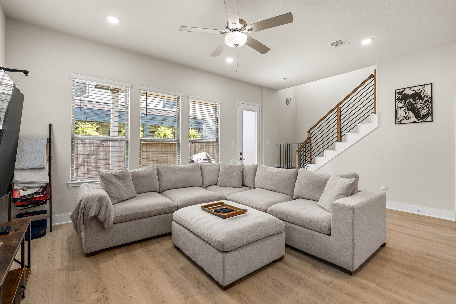 4001 Baja Lane, Houston, TX 77045 Warm wood accents and modern iron balusters bring architectural character to the staircase, complementing the durable luxury vinyl plank flooring that extends throughout the main living areas.