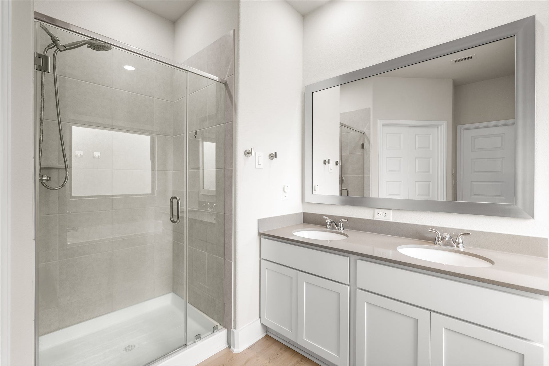 4001 Baja Lane, Houston, TX 77045 Dual vanities provide dedicated space for the morning routine, while the glass-enclosed shower offers a clean, modern design that enhances both form and function.