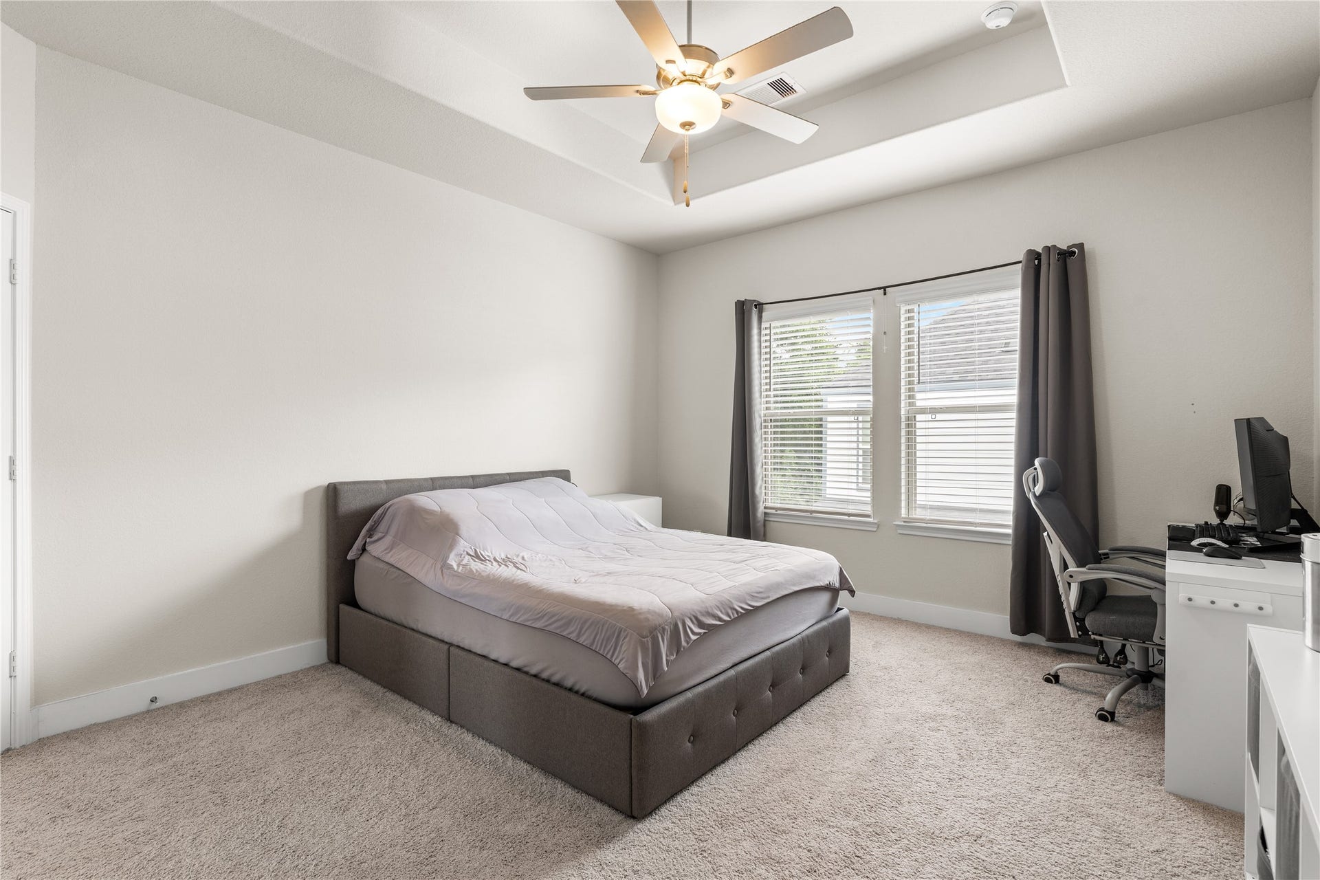 4001 Baja Lane, Houston, TX 77045 Even with a dedicated workspace and full bedroom furnishings, the primary suite retains a remarkable sense of openness, highlighting the thoughtful proportions of the room.