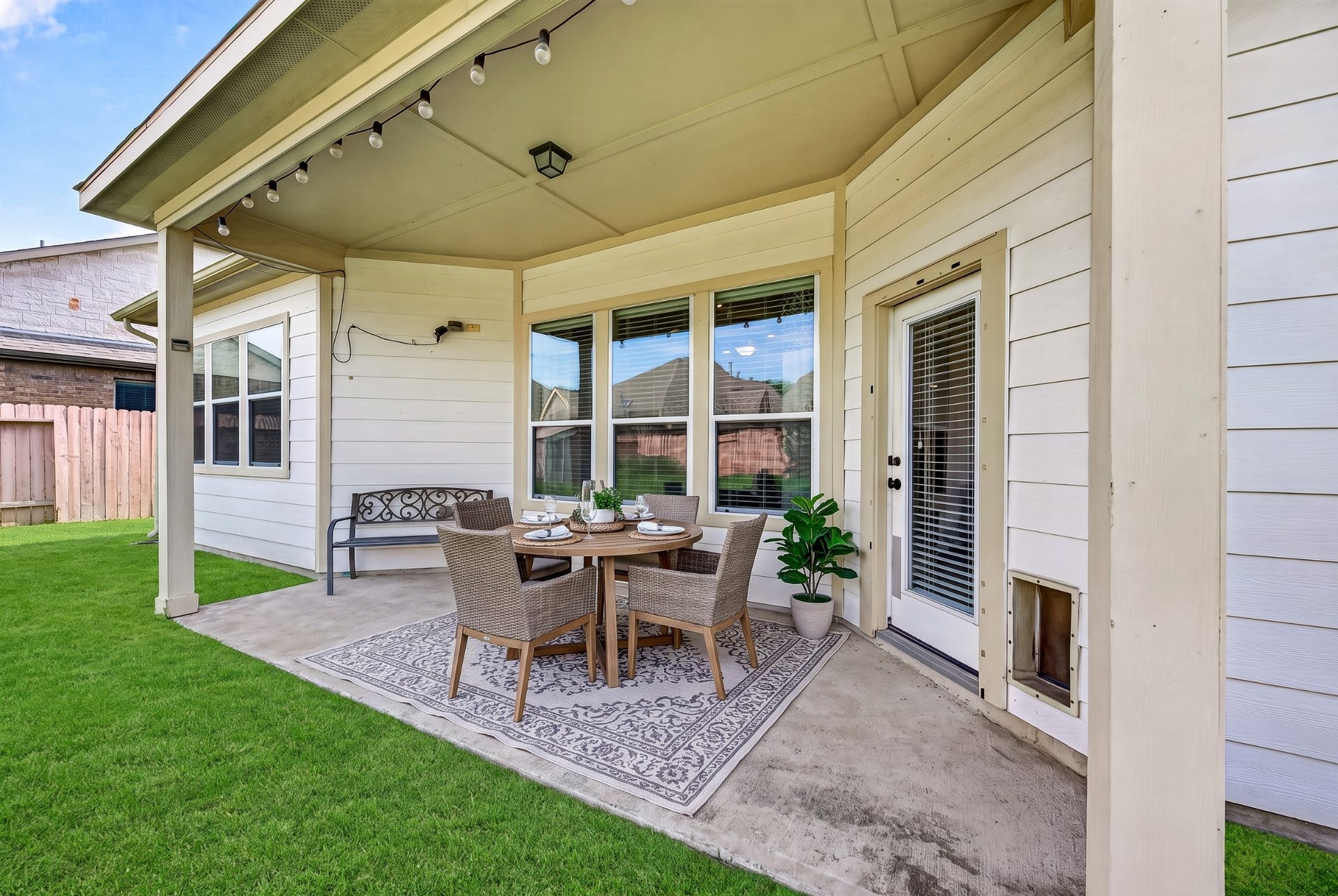 4314 Kent Ranch Court, Katy, TX 77494 Covered back patio - virtually staged. Ceiling light and large windows overlooking the yard.