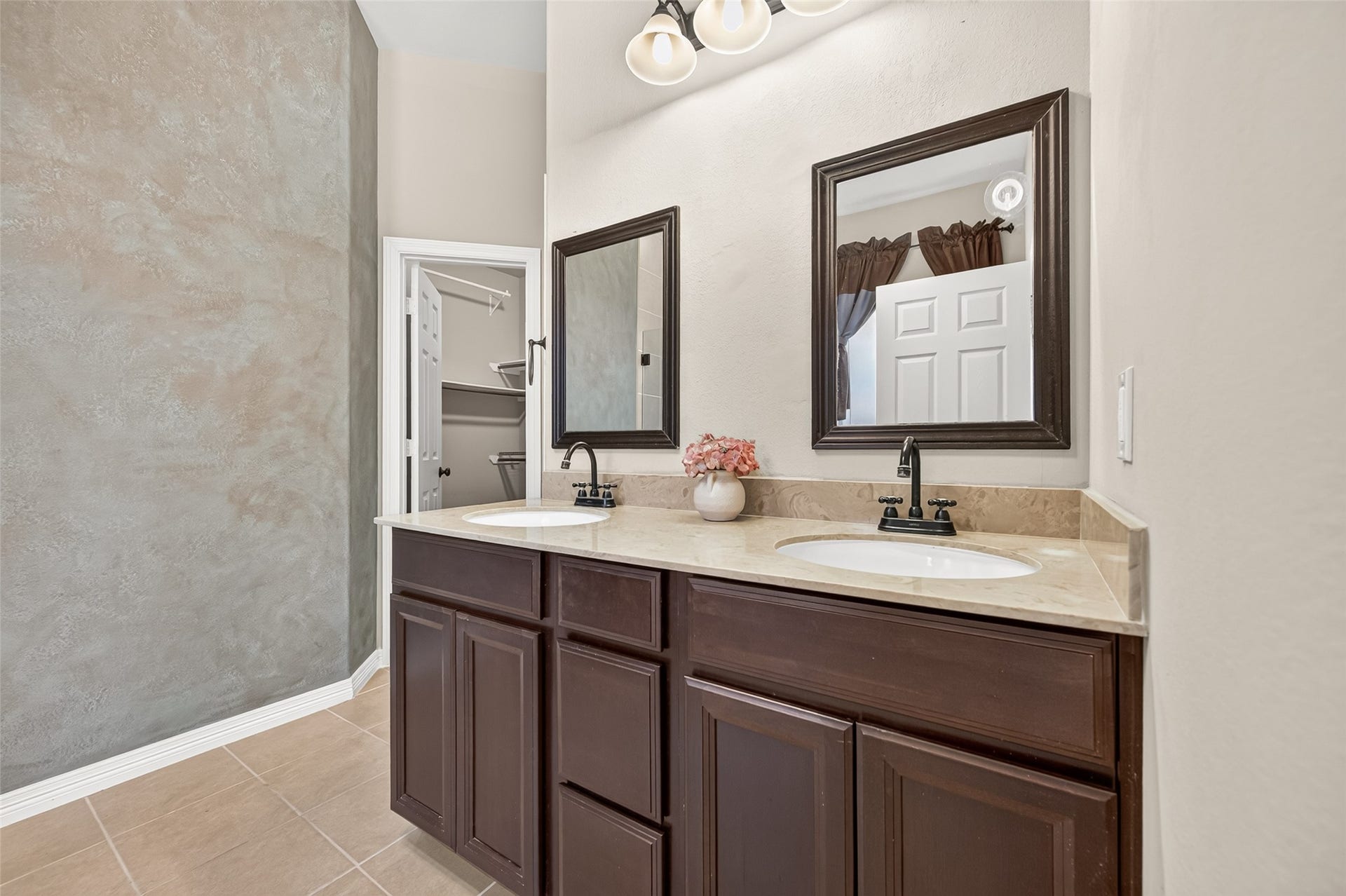 4314 Kent Ranch Court, Katy, TX 77494 Primary bath with dual sinks, espresso cabinetry, framed mirrors and tile flooring.