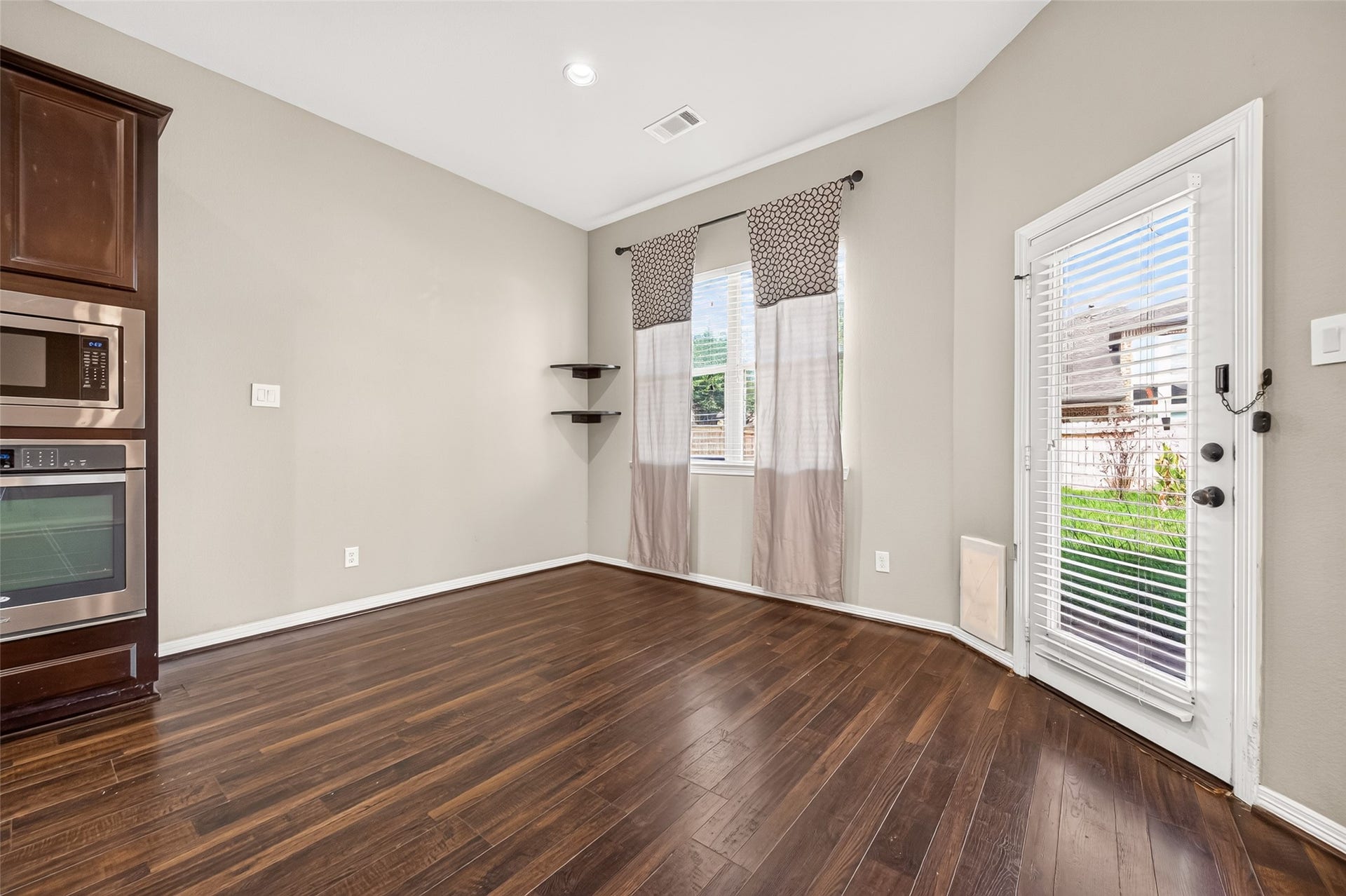 4314 Kent Ranch Court, Katy, TX 77494 Breakfast area with corner floating shelves, window and door with built-in blinds to the backyard.