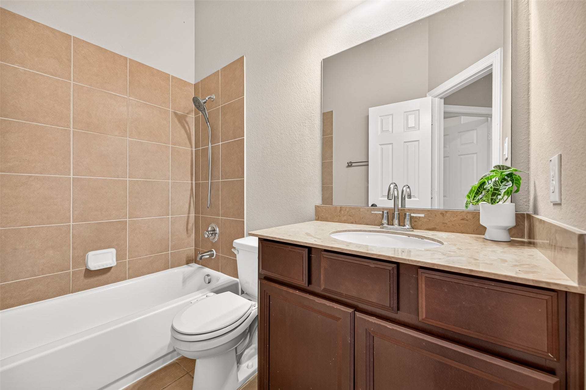 4314 Kent Ranch Court, Katy, TX 77494 Secondary bath with tub/shower combo, full tile surround and espresso vanity.