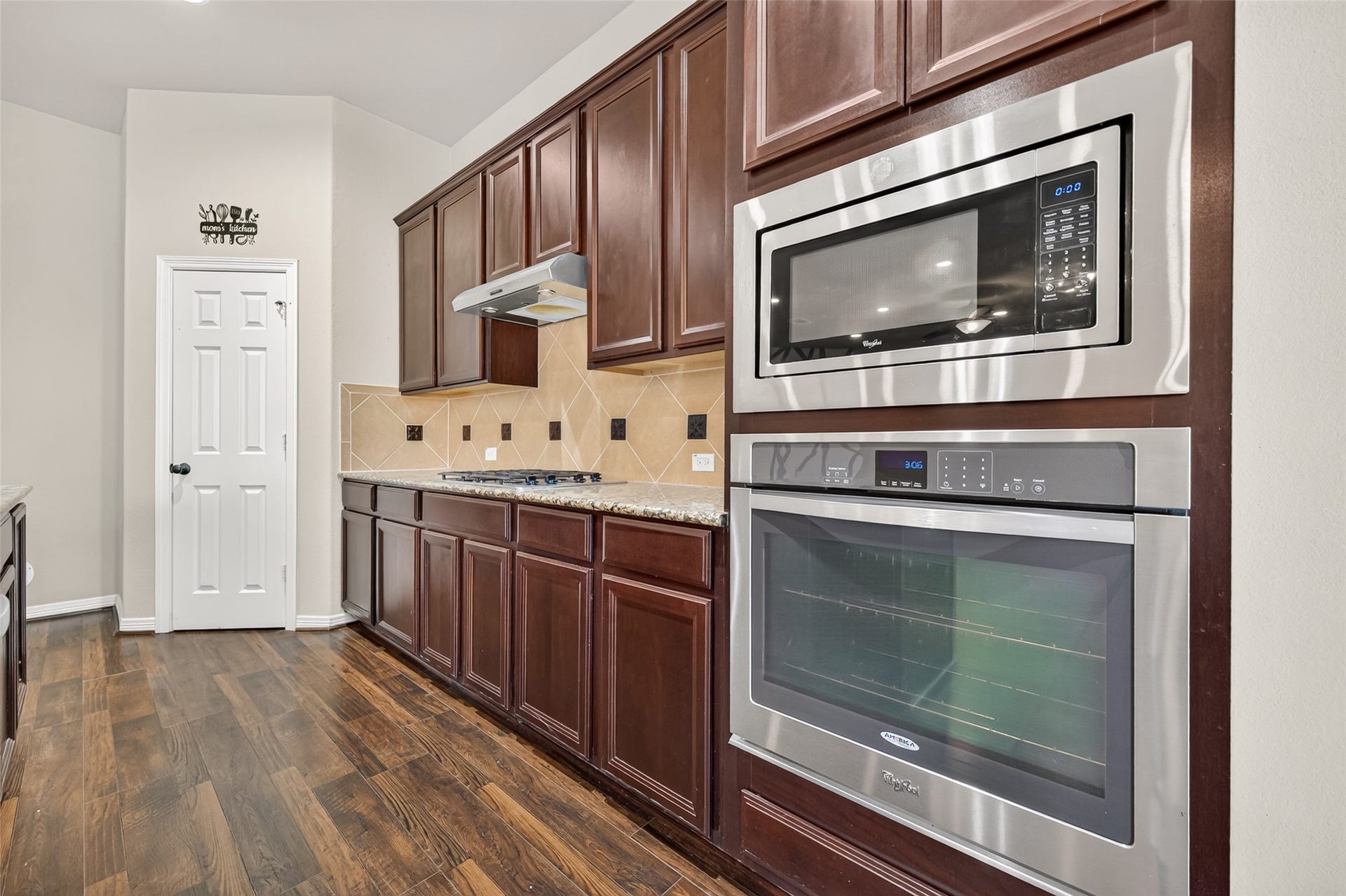 4314 Kent Ranch Court, Katy, TX 77494 Built-in stainless microwave and wall oven set in rich espresso cabinetry.