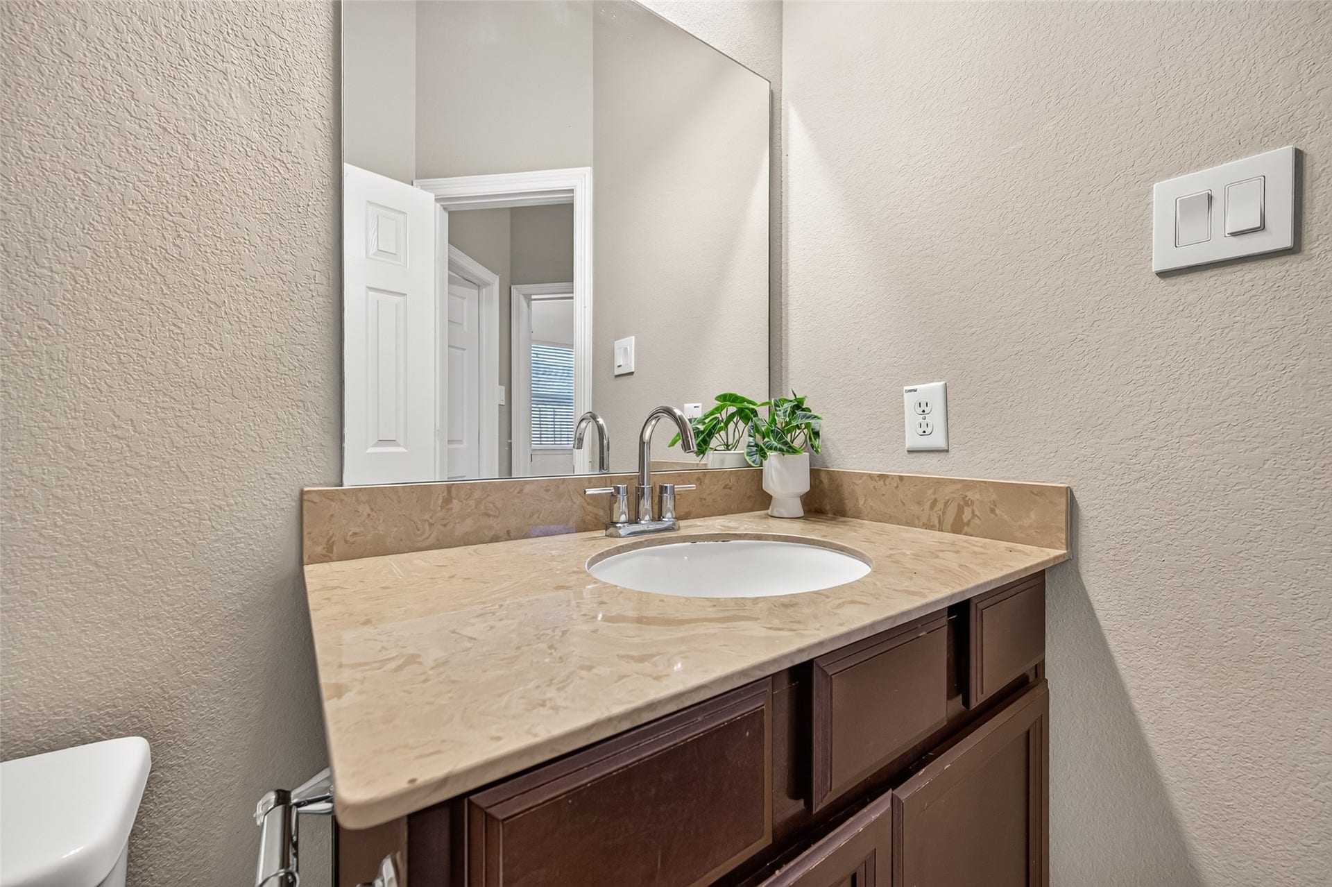 4314 Kent Ranch Court, Katy, TX 77494 Half bath with espresso vanity and framed mirror.