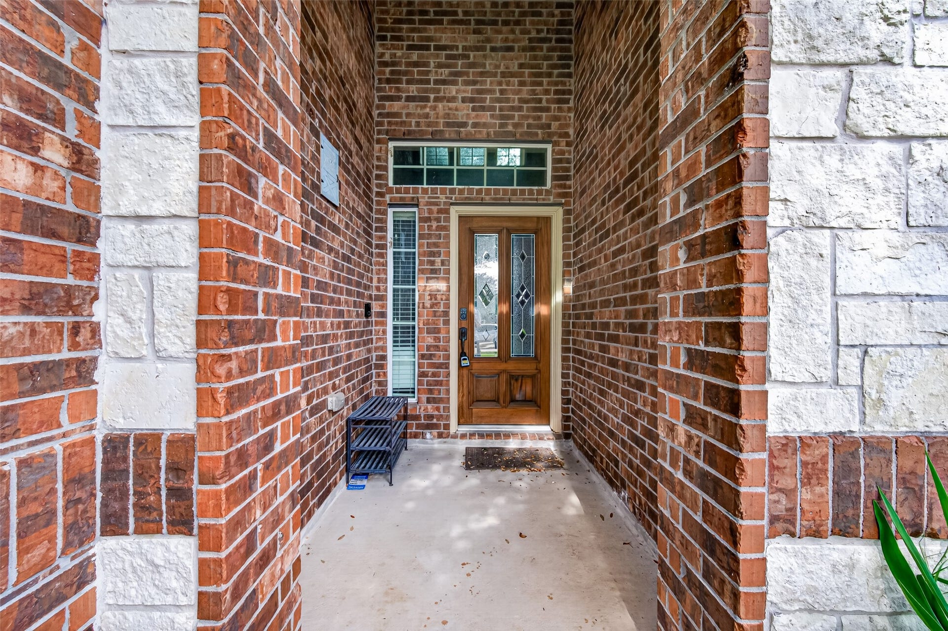 4314 Kent Ranch Court, Katy, TX 77494 Covered brick and stone entry with decorative glass front door, sidelight and transom window.