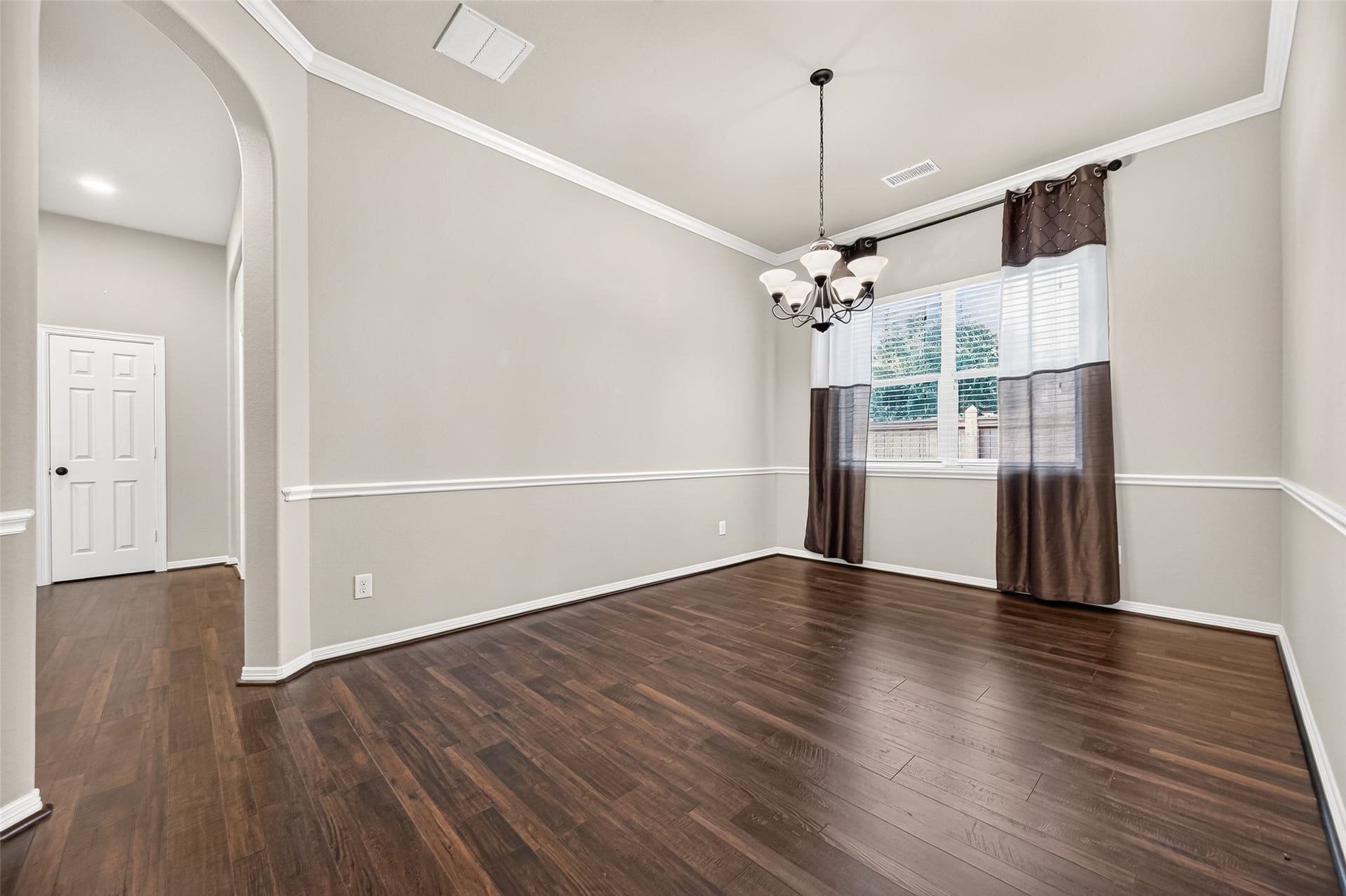 4314 Kent Ranch Court, Katy, TX 77494 Formal dining room with chandelier, chair rail, crown molding and large window.
