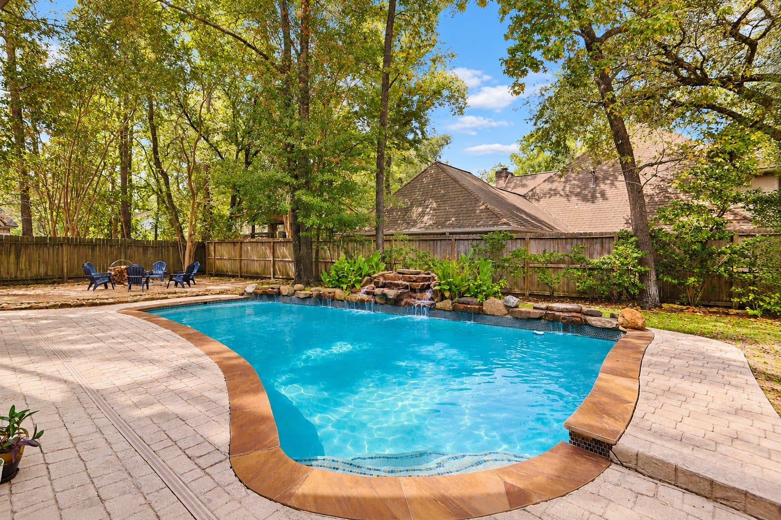 2713 N Logrun Circle, Spring, TX 77380 Your own private escapepoolside afternoons, the sound of cascading waterfalls and evenings around the firepit, all beneath the shade of mature Woodlands trees