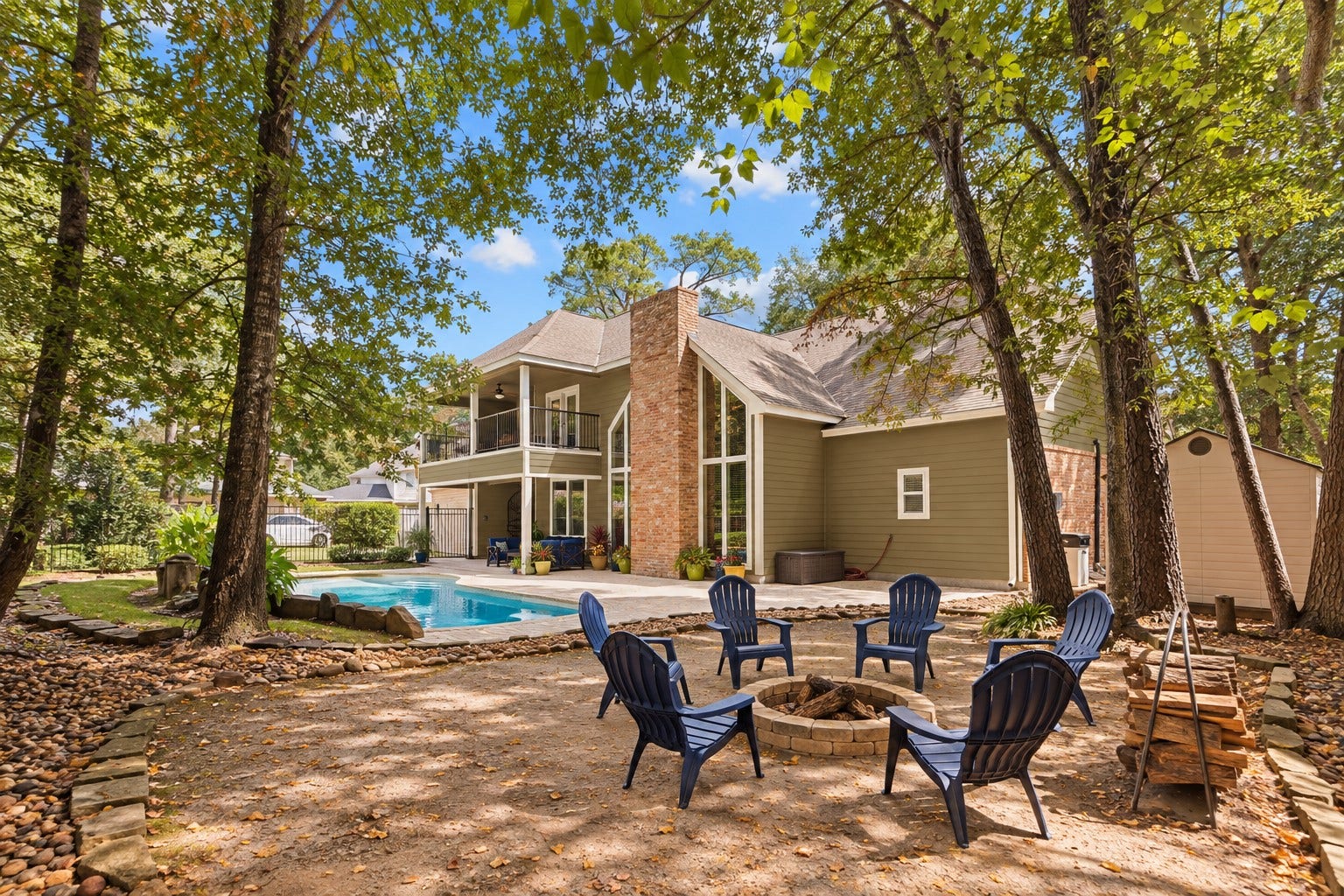 2713 N Logrun Circle, Spring, TX 77380 Gather around the firepit beneath a canopy of mature treesanother inviting outdoor space that makes this backyard feel like a private retreat