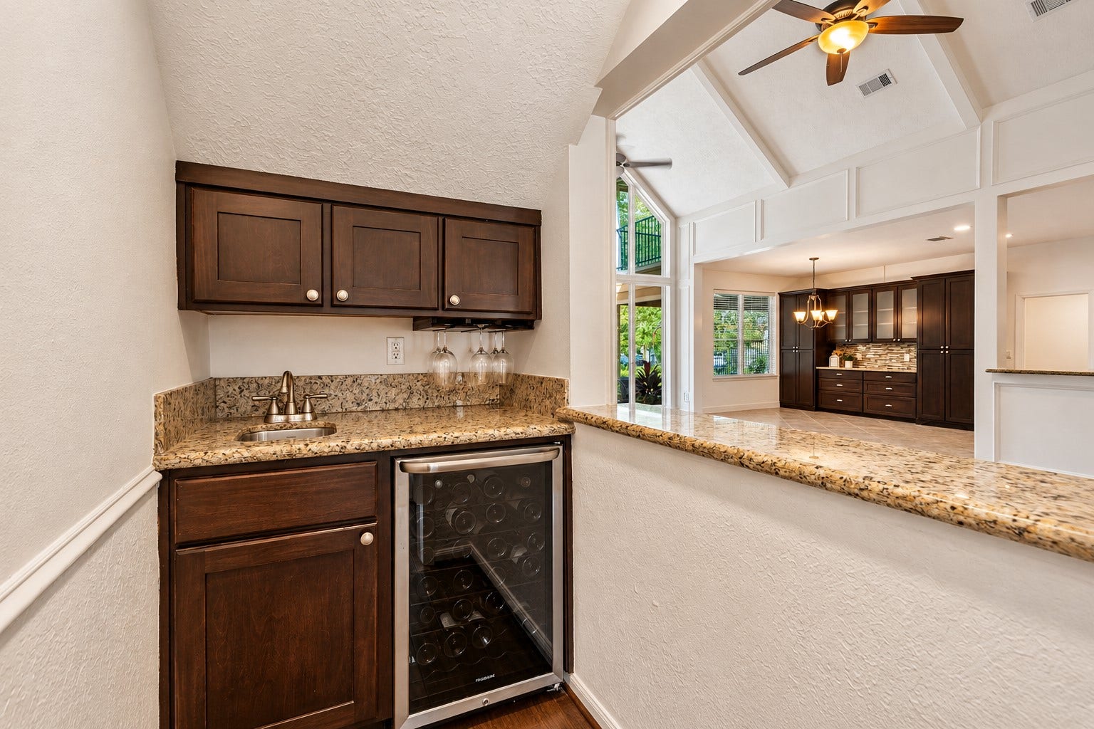 2713 N Logrun Circle, Spring, TX 77380 Perfectly positioned for entertaining, the wet bar connects directly to the Family Room and features granite counters, a sink, wine chiller & generous storage for glassware and spirits.