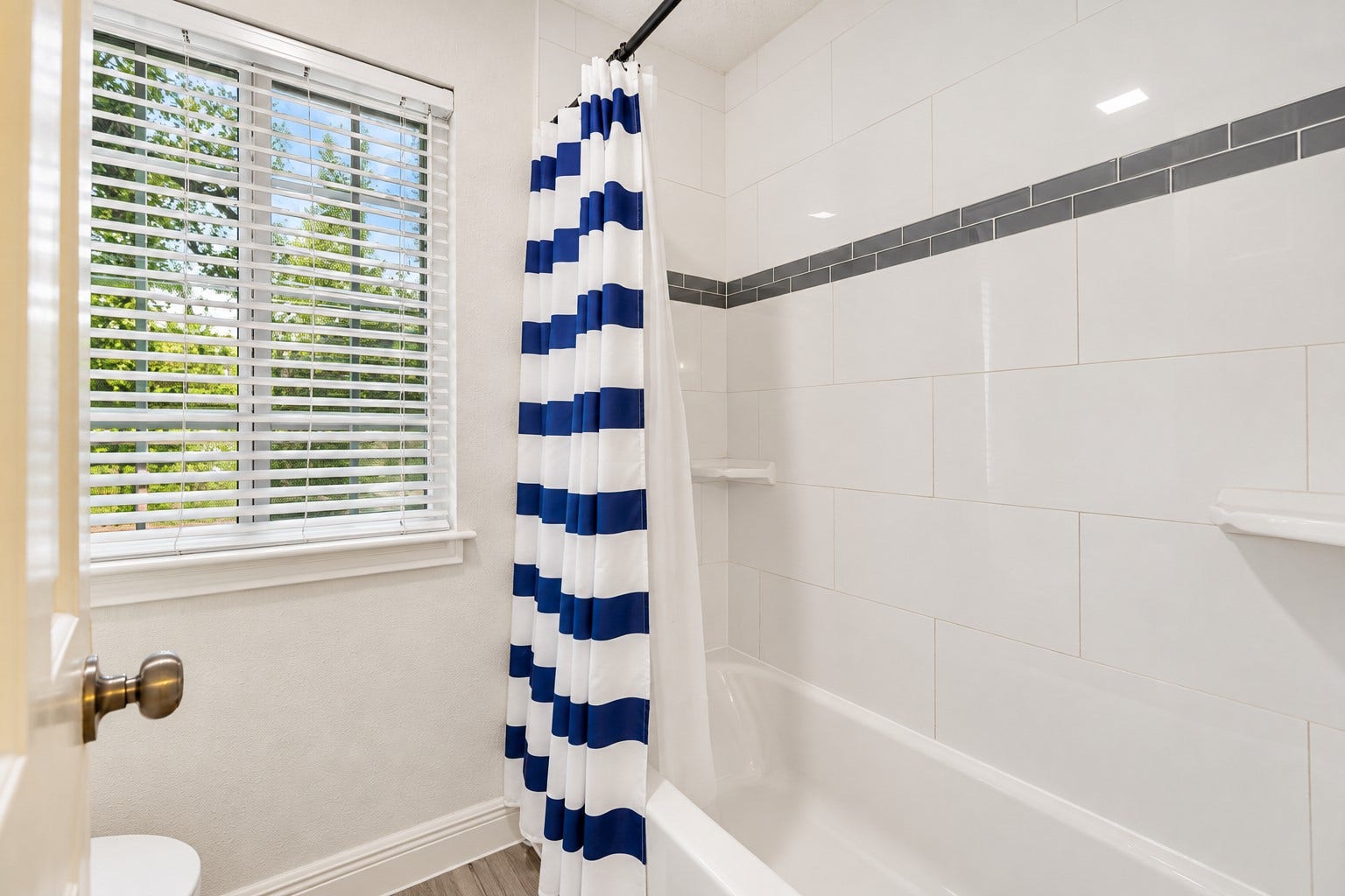 2713 N Logrun Circle, Spring, TX 77380 A privacy door separates the shared tub/shower & toilet area from the dual vanity spaces, allowing the Jack-and-Jill bath to function easily for two bedrooms. Updated tile surround completes the clean, fresh look.