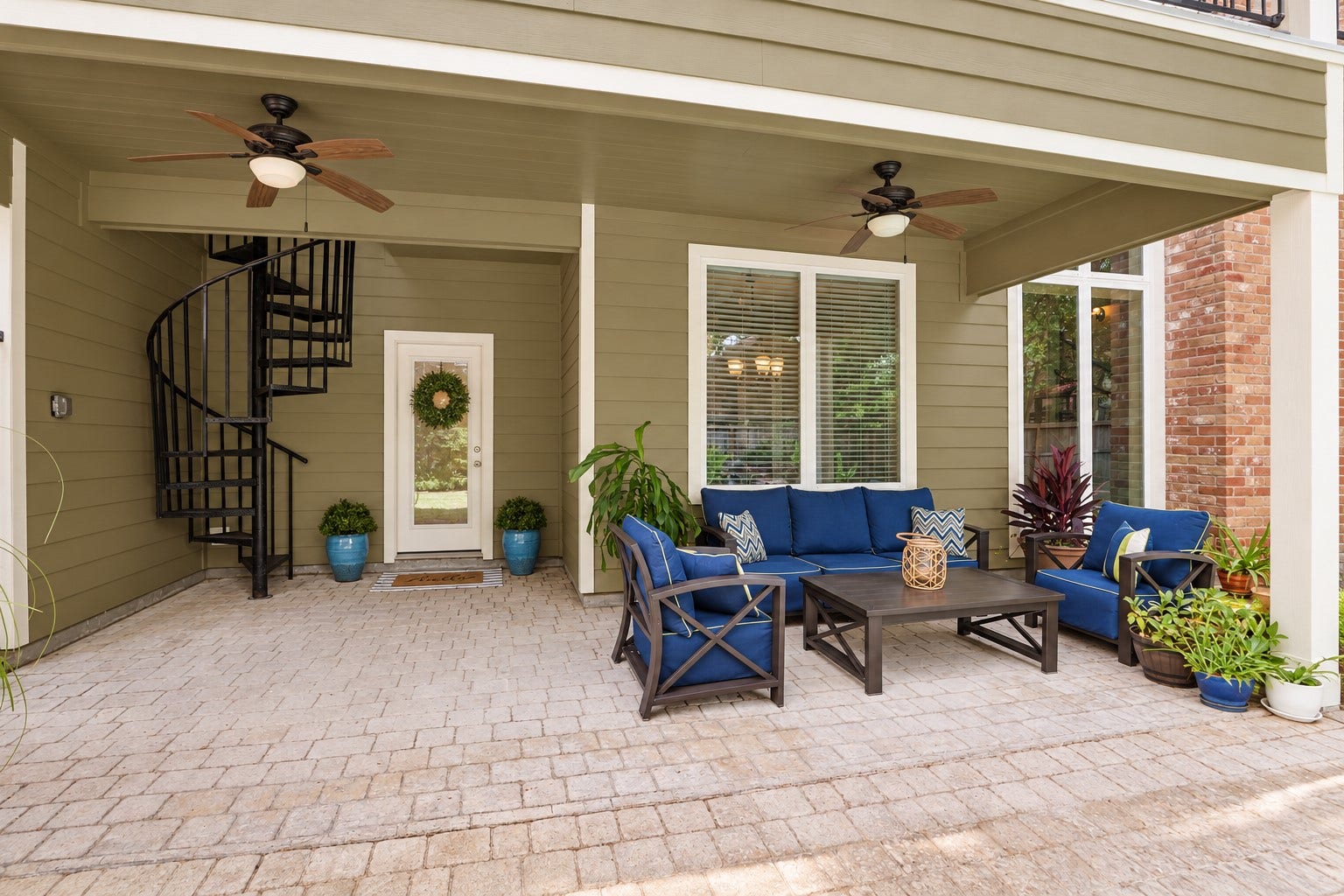2713 N Logrun Circle, Spring, TX 77380 The homes everyday entrance is tucked beneath a spacious covered patio, creating a welcoming & weather-protected arrival for family and guests. The spiral staircase provides access to the upstairs balcony.