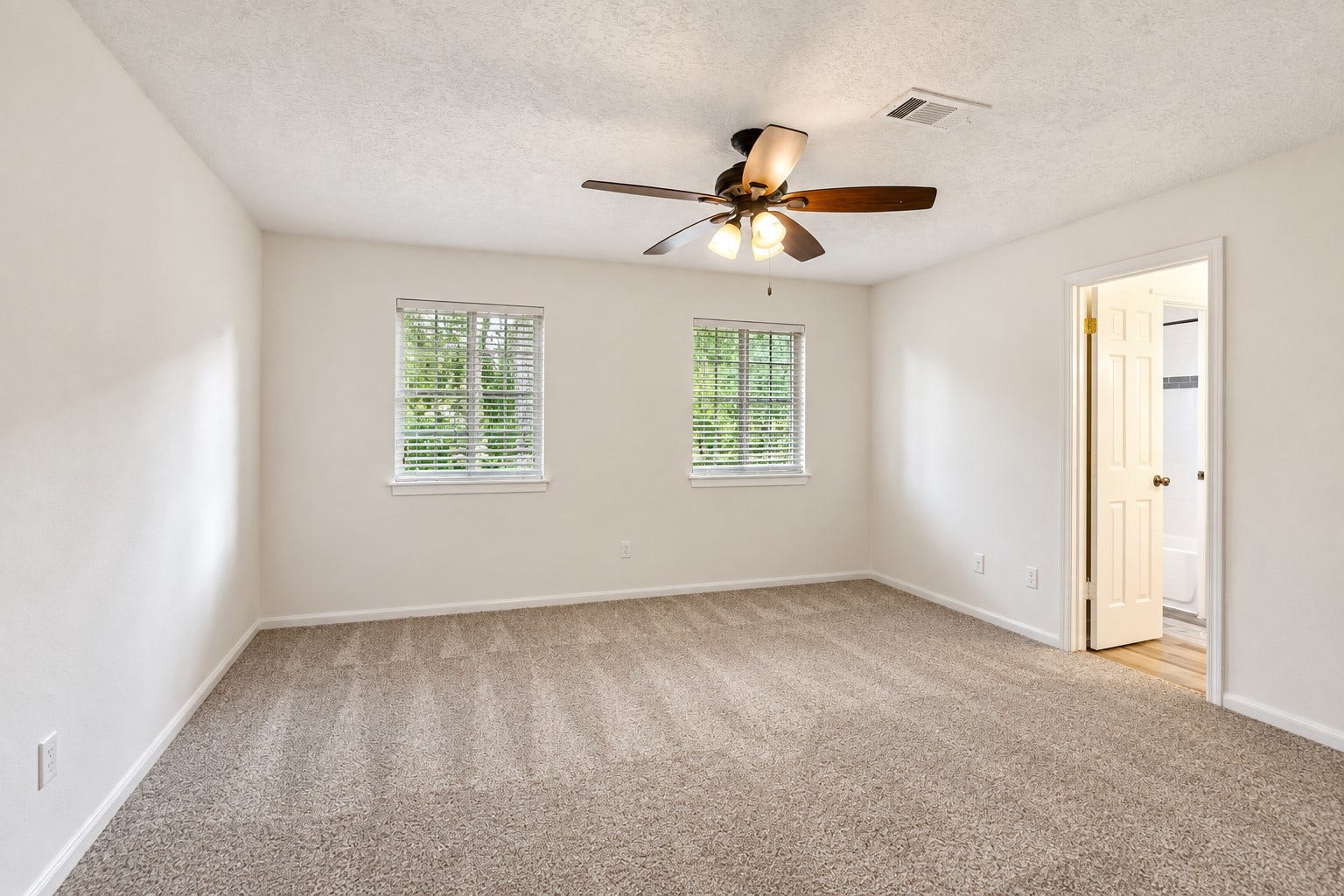 2713 N Logrun Circle, Spring, TX 77380 The third upstairs bedroom features a fresh neutral palette, carpeting, walk-in closet & ceiling fan, while two windows bring in natural light. Direct access to the Jack-and-Jill bath completes this comfortable, practical space.