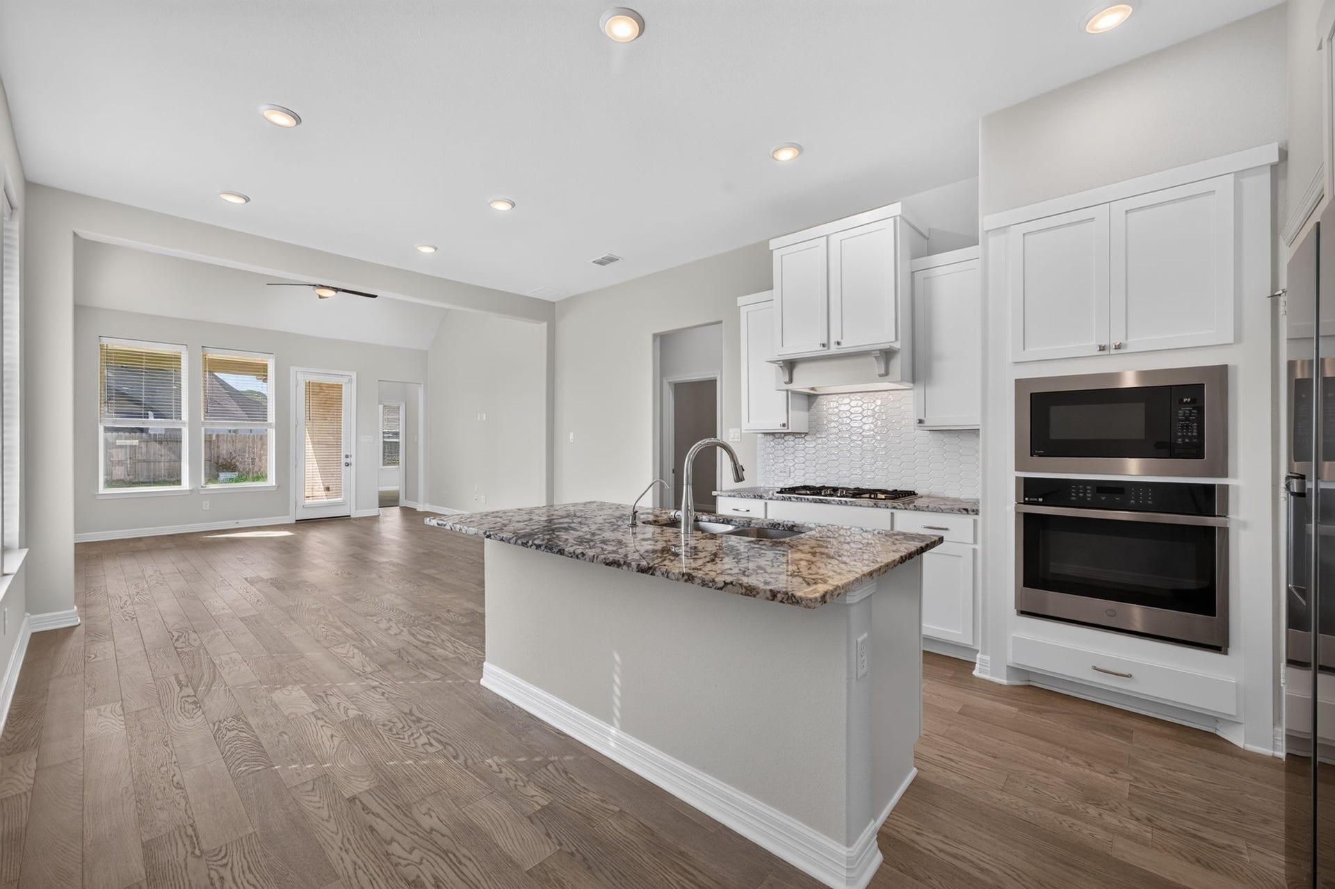 24638 Carleton Lake Lane, Tomball, TX 77375 Open layout has adjoining kitchen, dining and living rooms, perfect for engaging with family and friends.