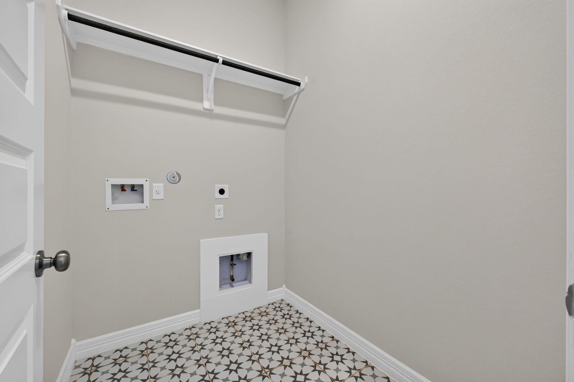 24638 Carleton Lake Lane, Tomball, TX 77375 Laundry Room has a great-looking patterned floor with convenient shelf and hanging rod.