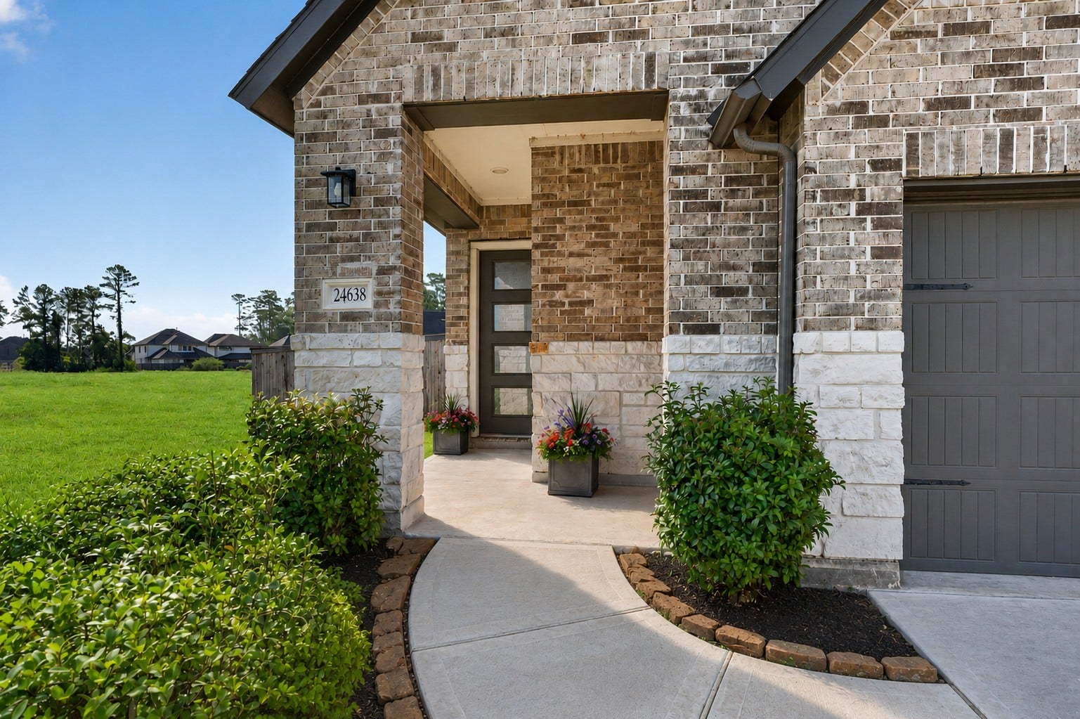 24638 Carleton Lake Lane, Tomball, TX 77375 Stone and brick facade in appealing neutral tones add character and style. The rock lined walkway with landscaped beds adds color and softness creating a welcoming presence.