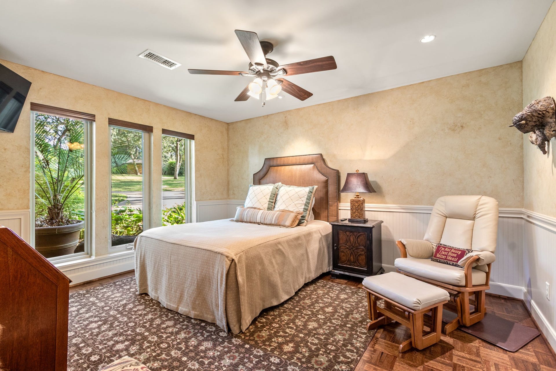23107 Kobs Road, Tomball, TX 77377 This cozy bedroom features a large window with garden views, neutral tones, ceiling fan, and beaded board accents.