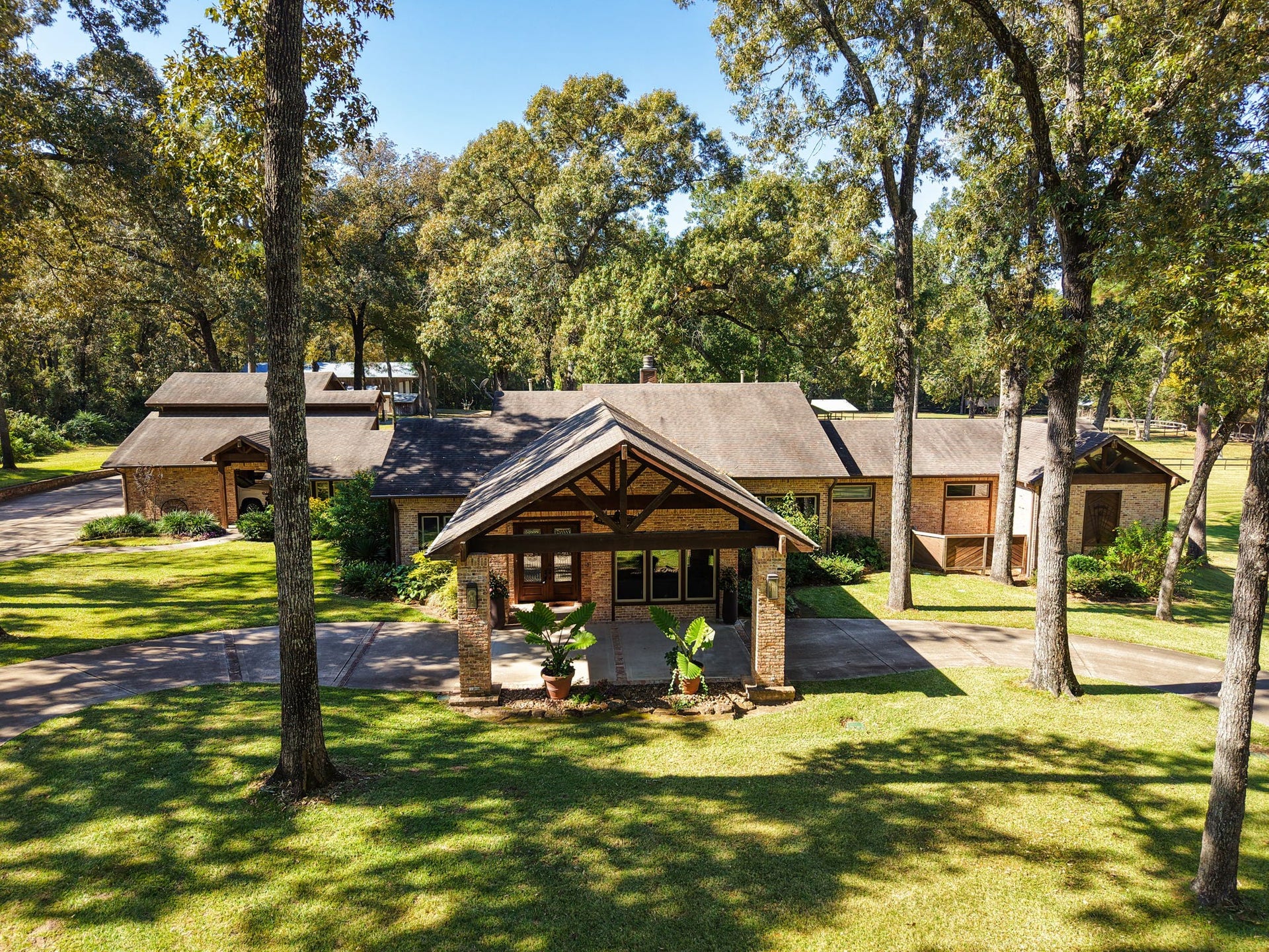 23107 Kobs Road, Tomball, TX 77377 This charming home is nestled among mature trees, offering a serene and spacious front yard. The brick exterior and inviting entryway create a welcoming atmosphere. A perfect blend of nature and comfort for your next home.