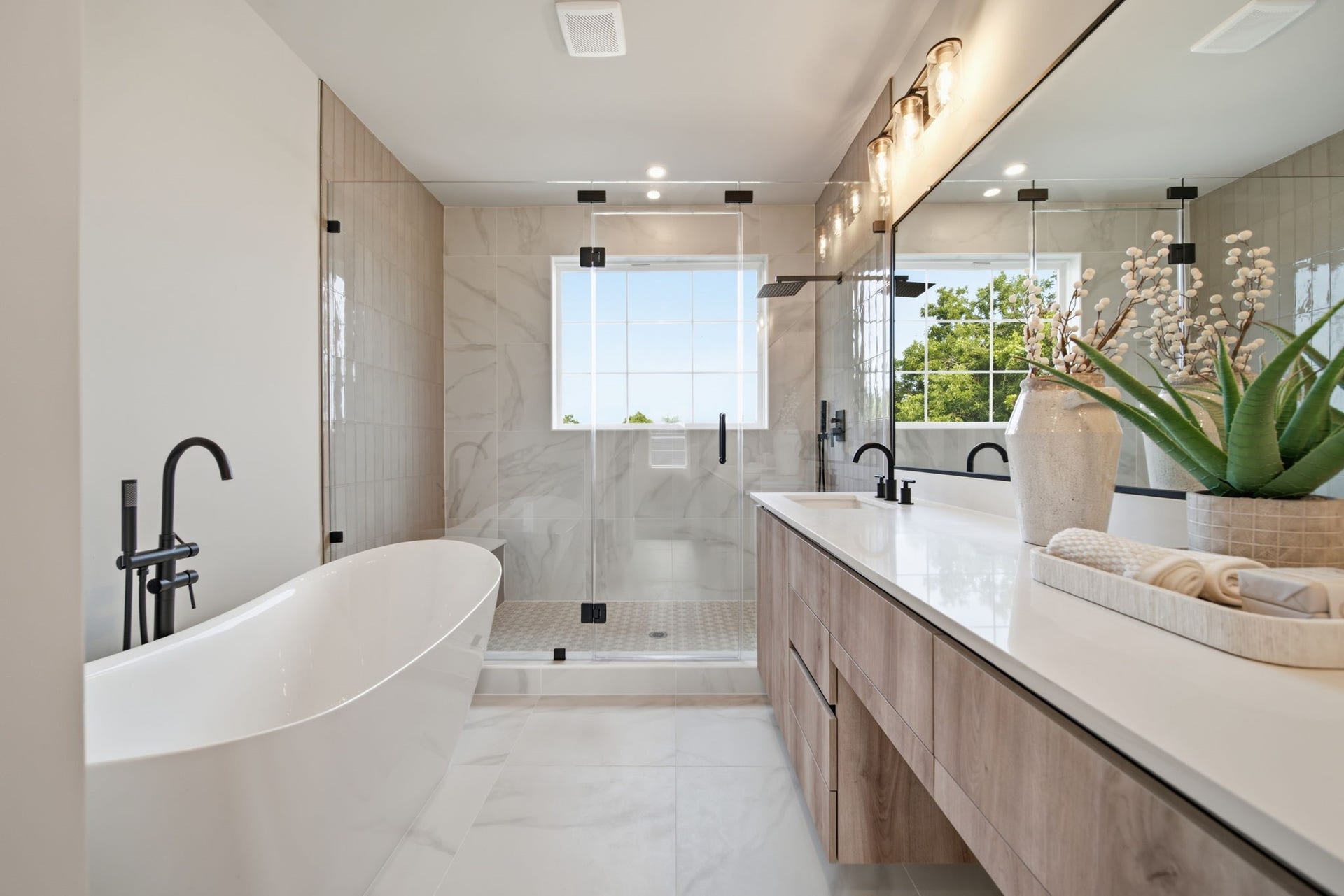 Soaking tub and oversized walk-in shower in the primary bathroom